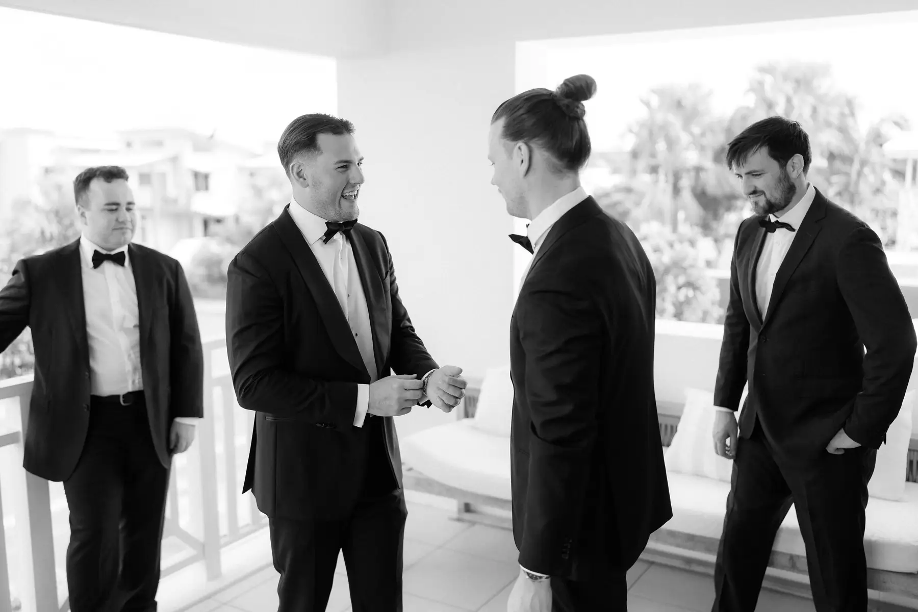 The groomsmen sharing a laugh on the balcony before the ceremony, Botanica Plantation House