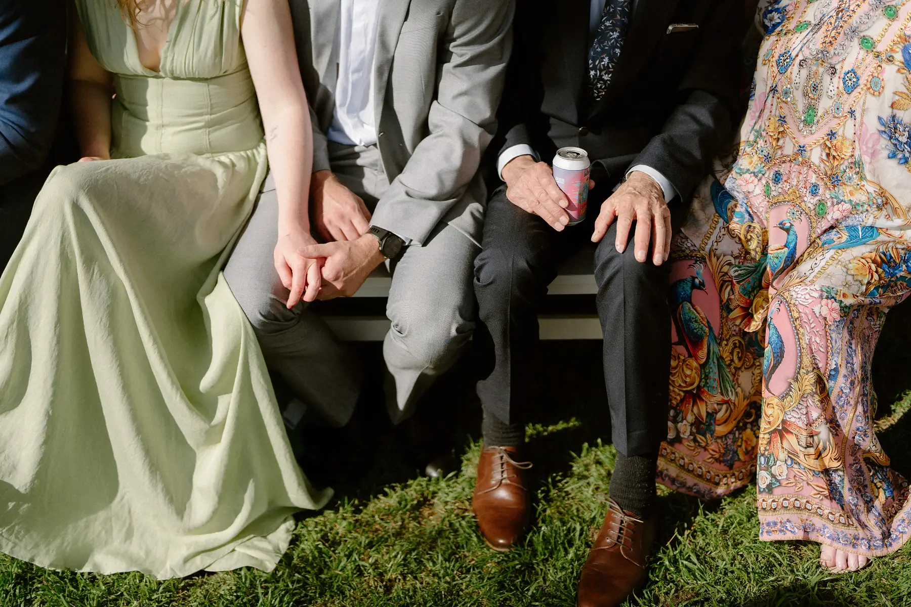 Guests holding hands on the benches as they wait for the ceremony, Botanica Plantation House