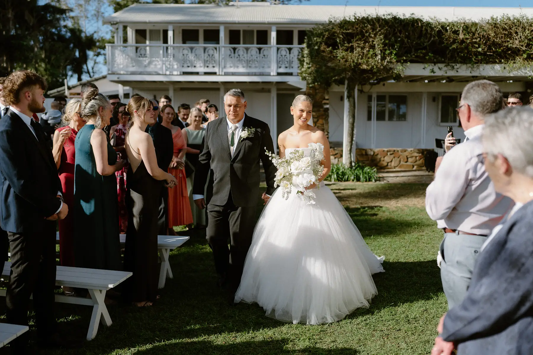 Georgia and her father making their way through the guests, Botanica Plantation House