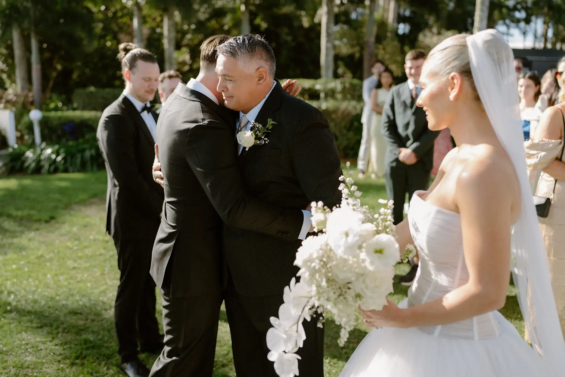 A hug between Kaes and Georgia's father before the vows, Botanica Plantation House