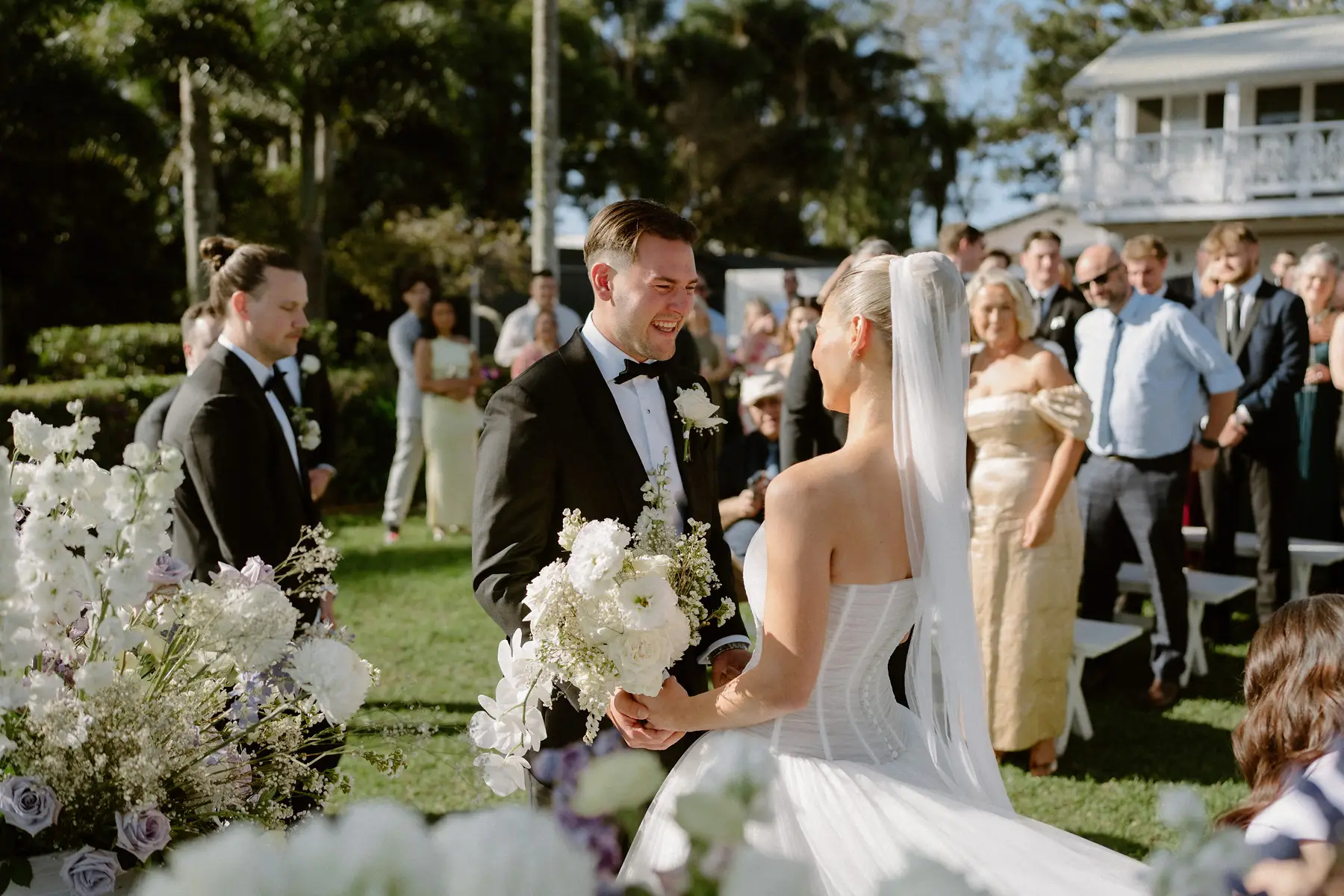 Laughter during the ceremony under the Poinciana, Botanica Plantation House
