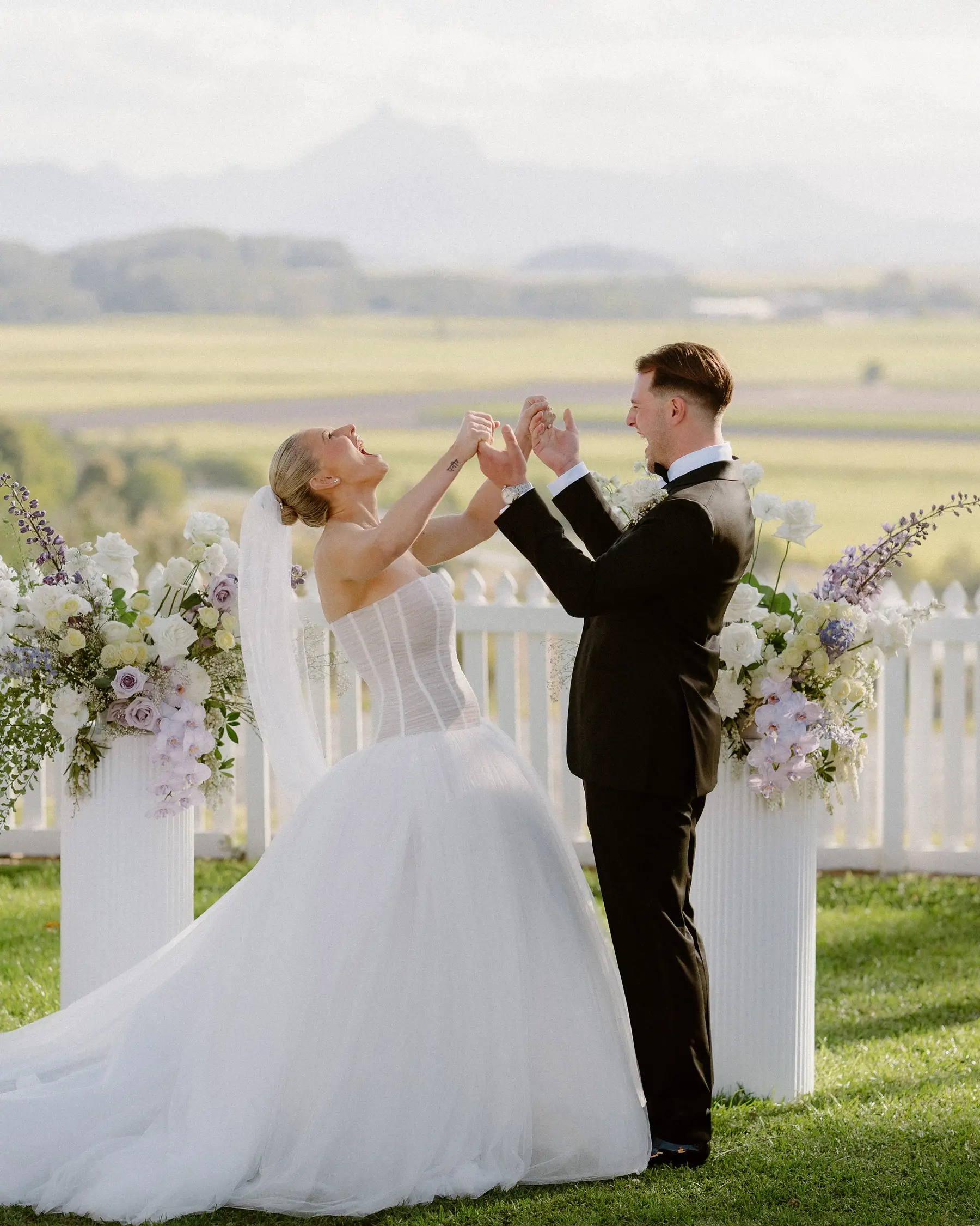 Hands raised as Georgia and Kaes are announced married, Botanica Plantation House