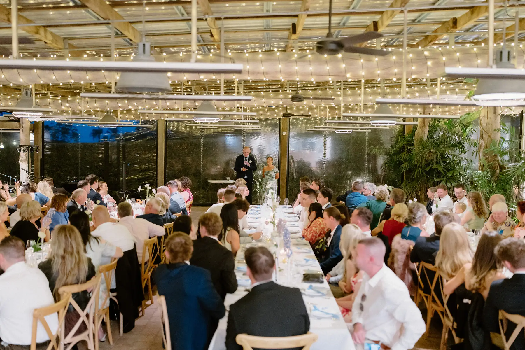 Guests listening to the speeches at the long tables, Botanica Plantation House