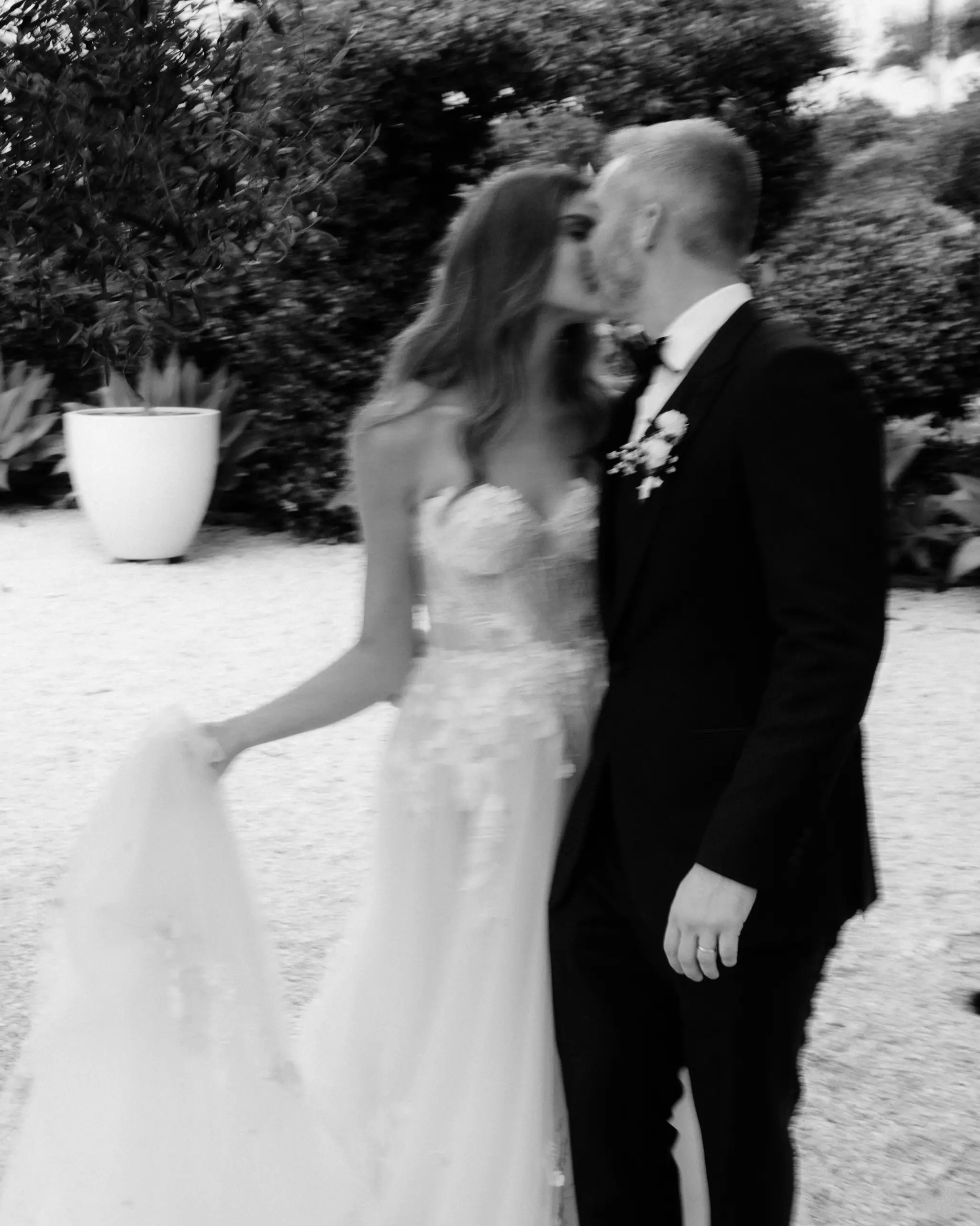 Couple kissing in a garden, motion blur