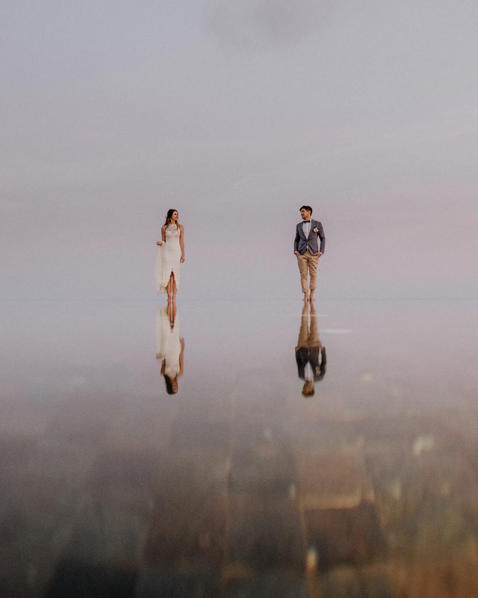 Couple reflected in still water