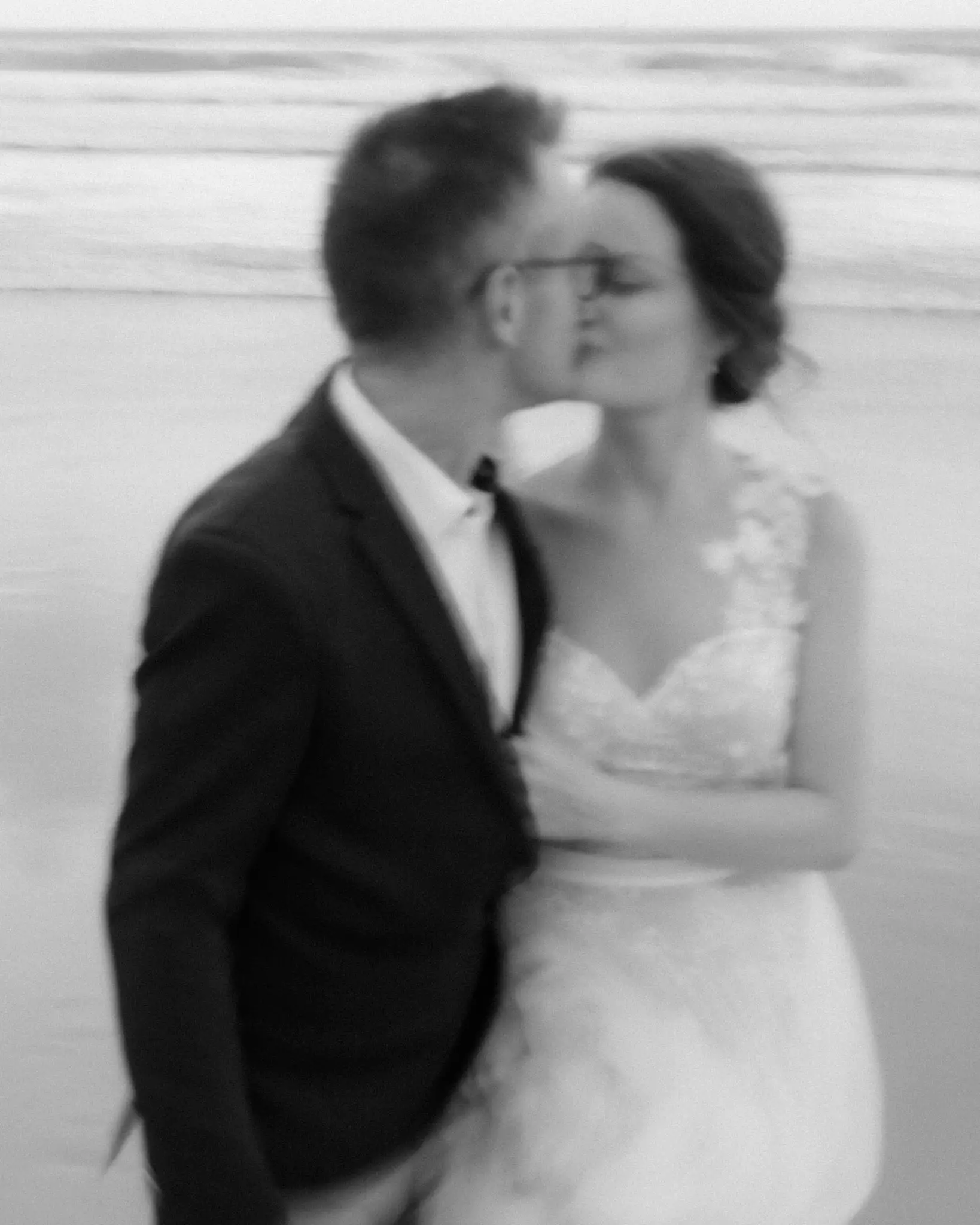 A kiss caught in motion blur, in black and white
