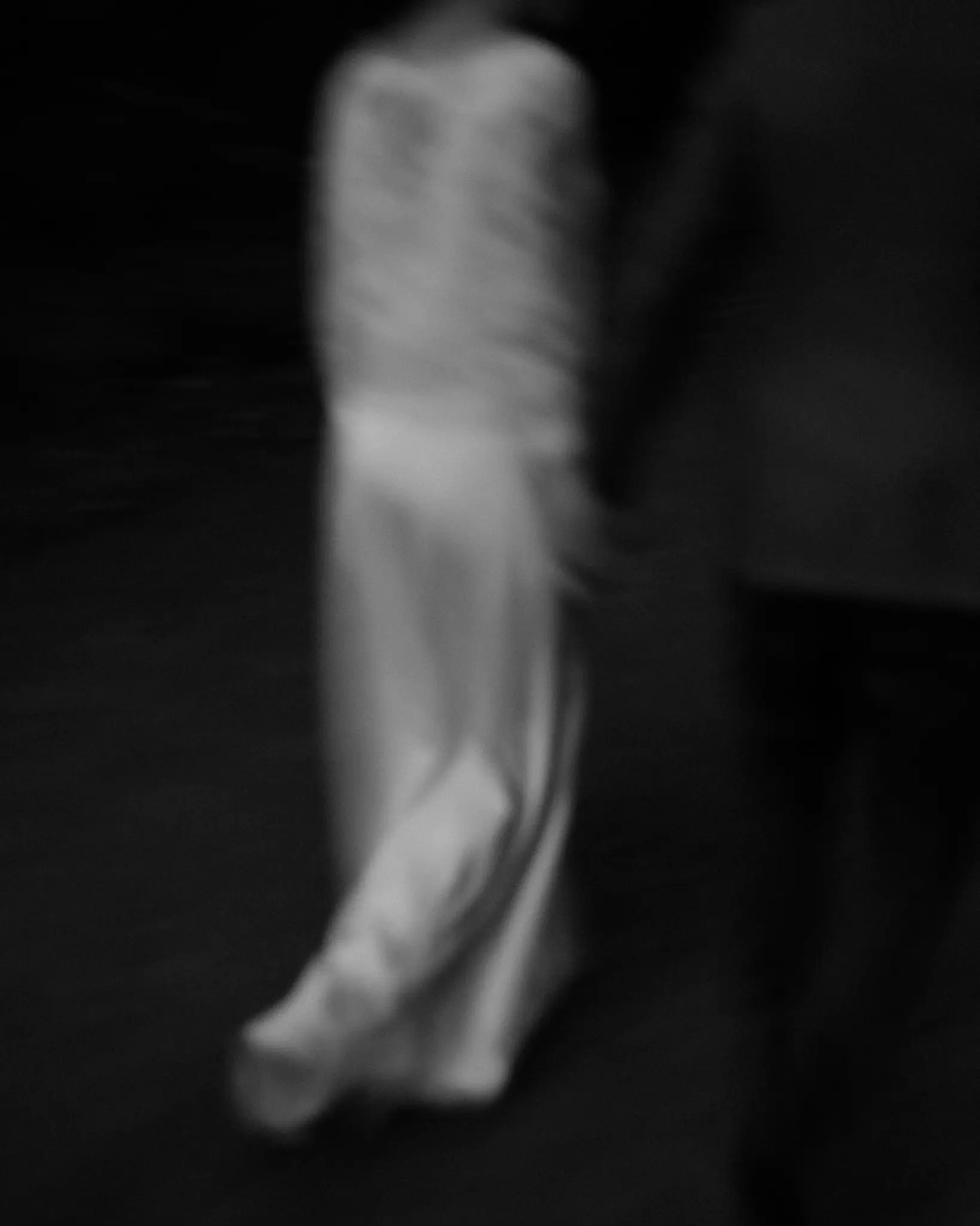 The dress in motion on a dark street, in black and white