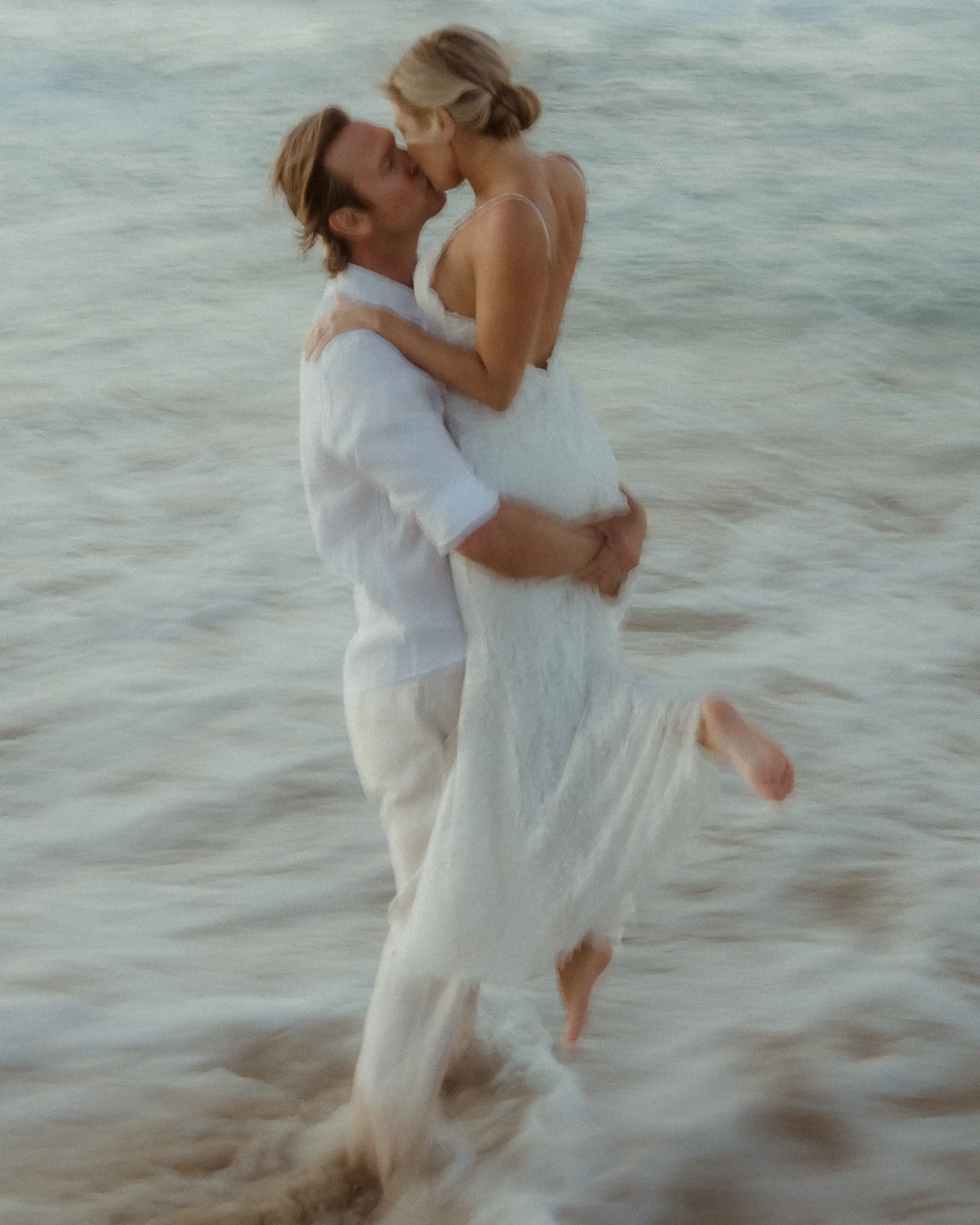 Couple embracing waist-deep in the sea