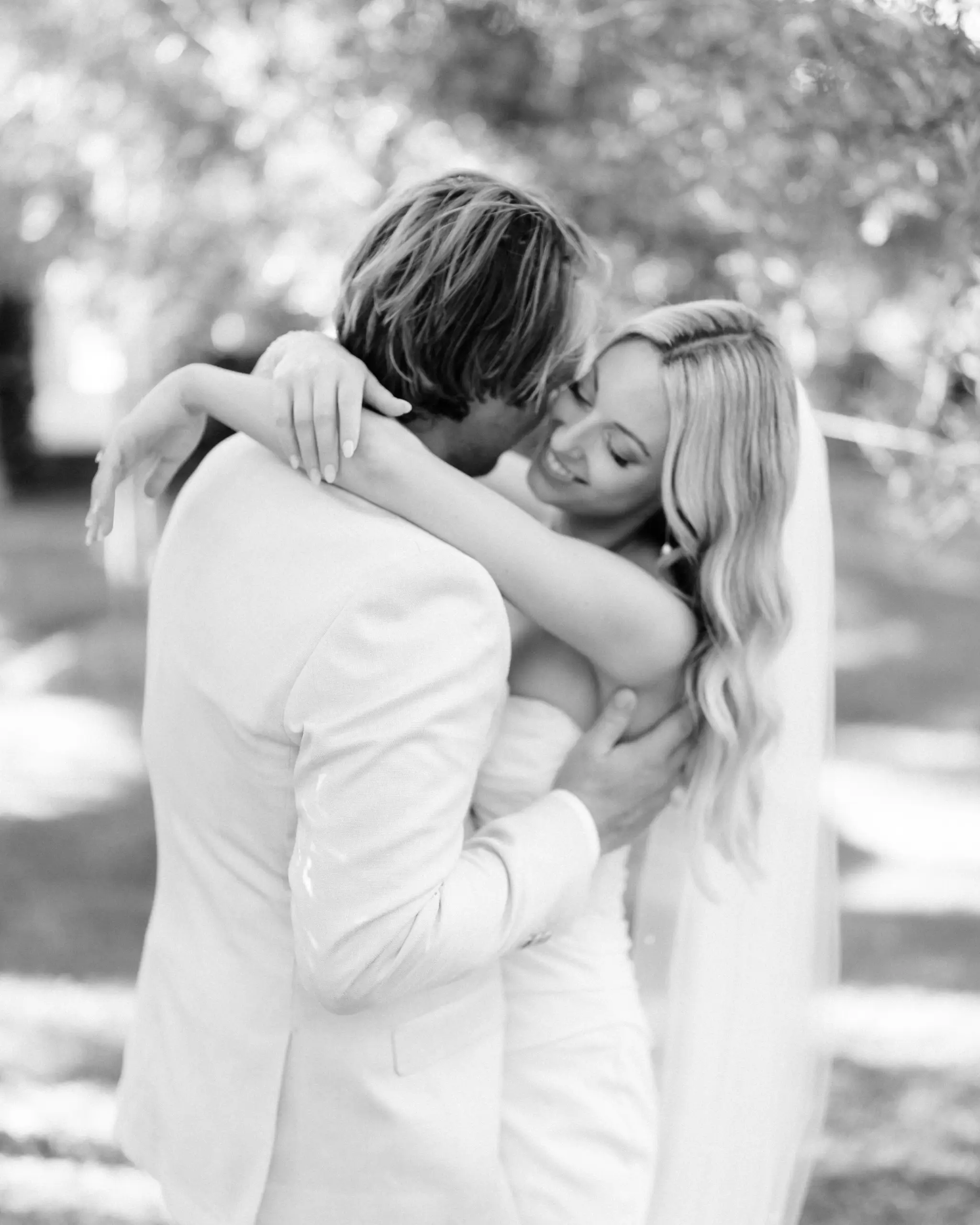 An embrace in dappled light, in black and white