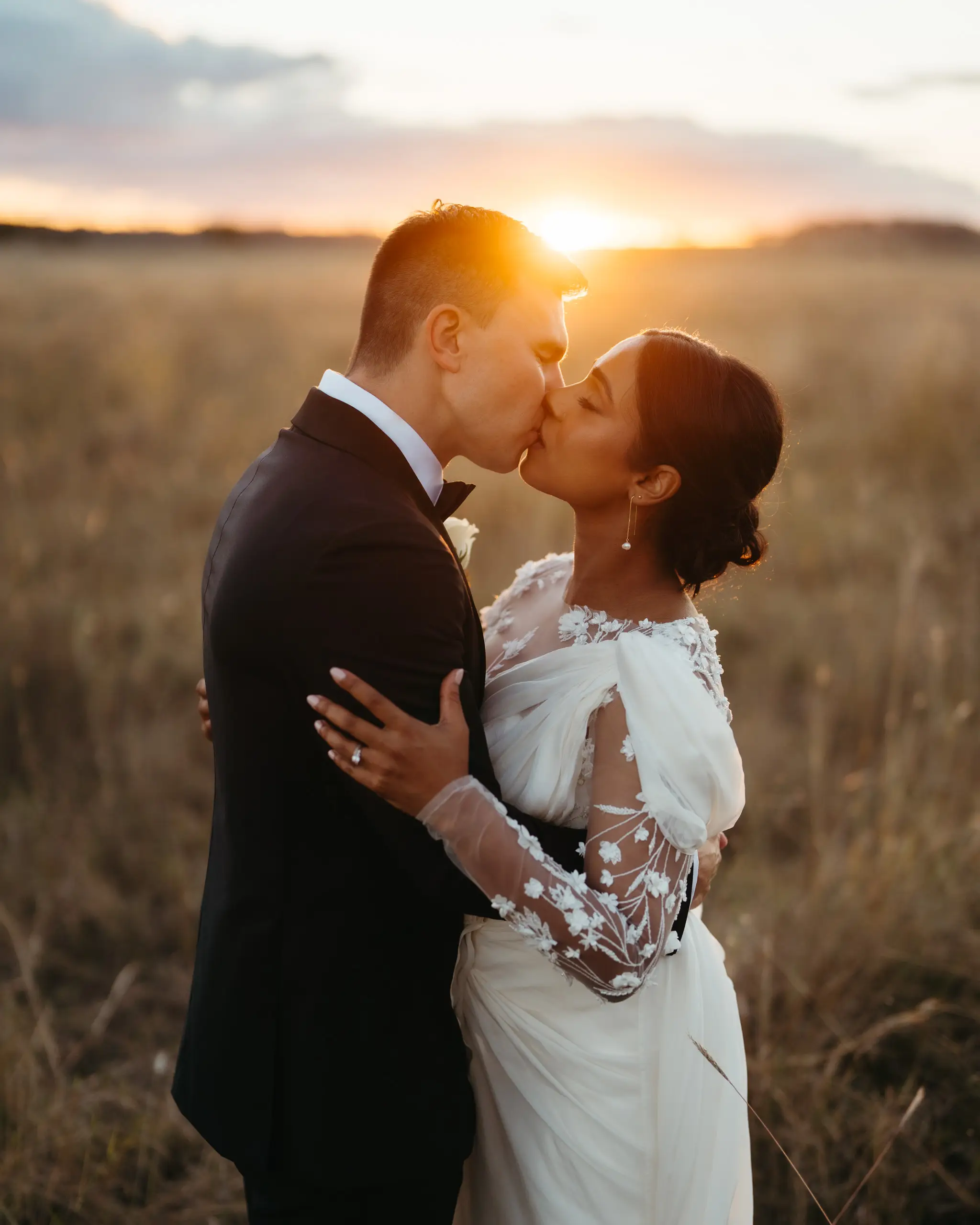 A kiss into the setting sun across open paddocks