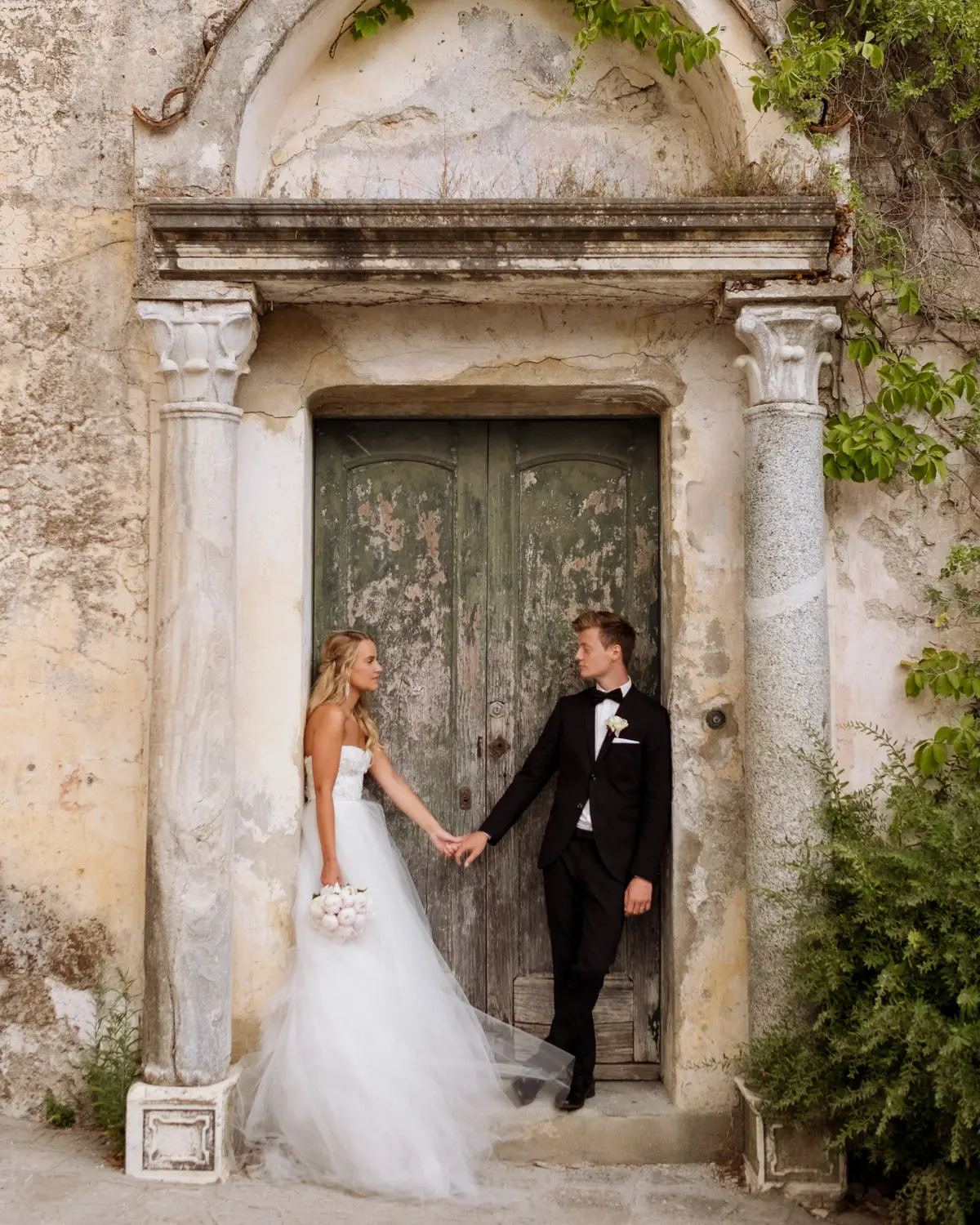 Bride and groom at an ancient stone doorway