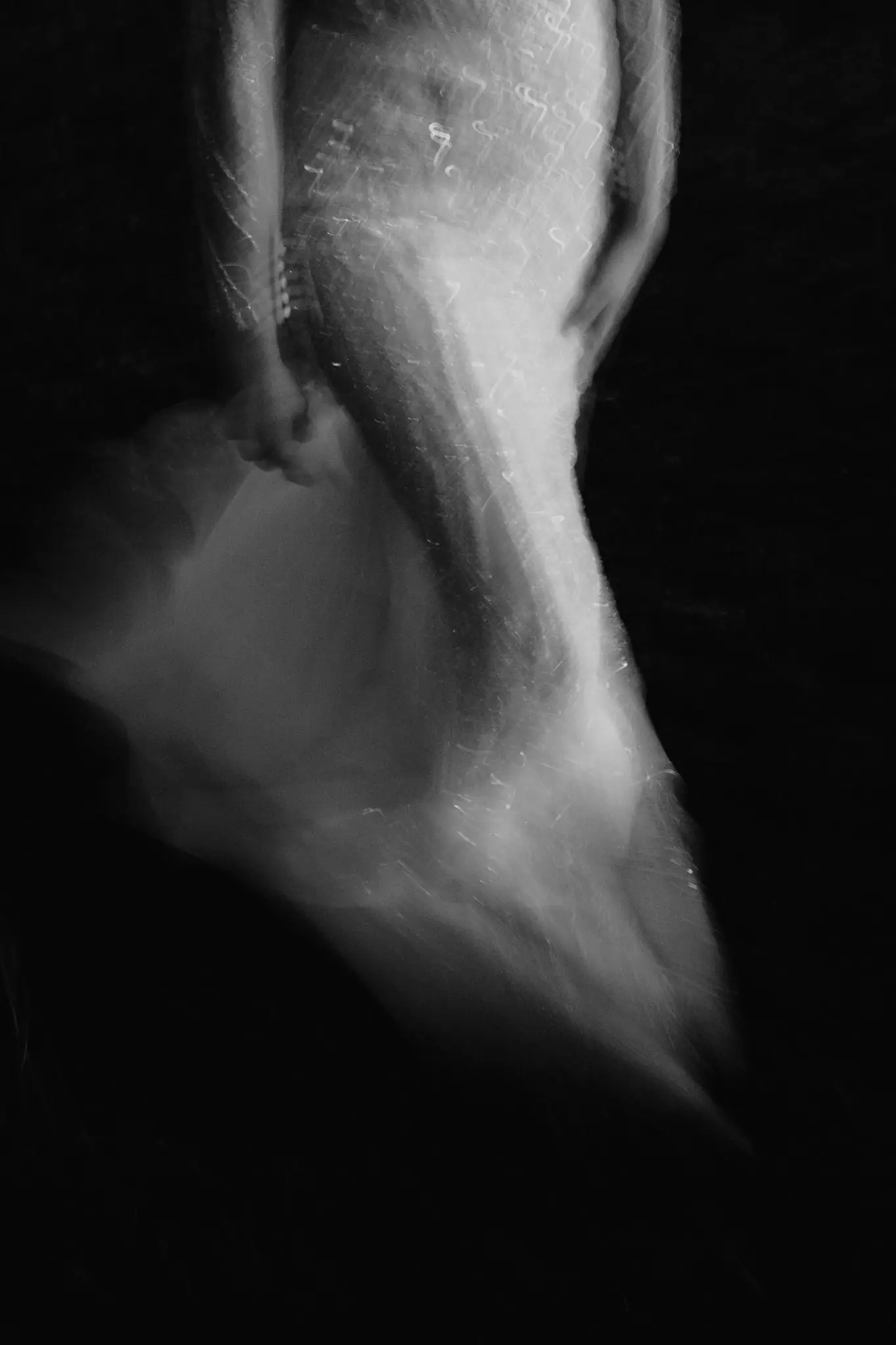 The dress trailing underwater in the dark