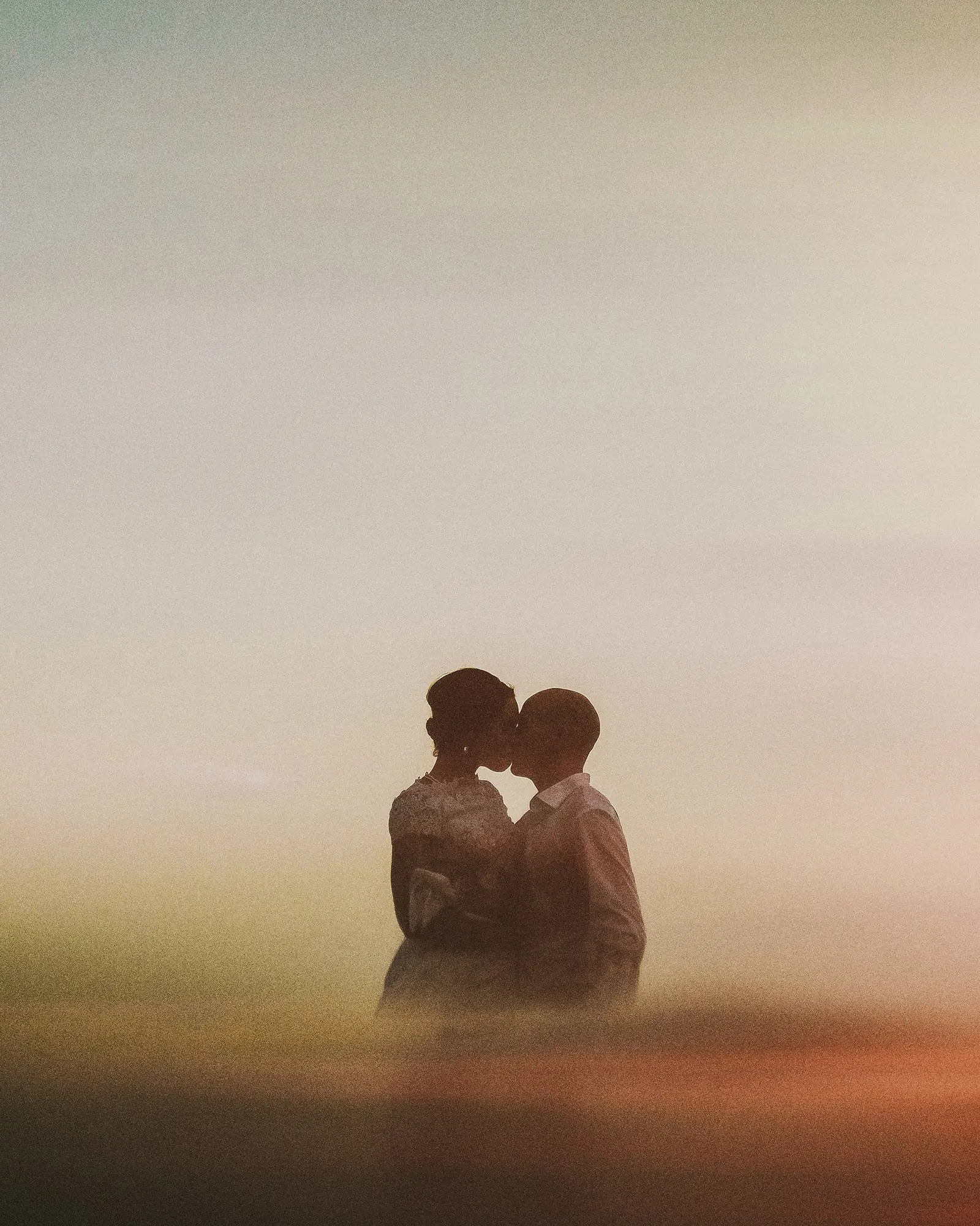Couple embracing in warm sea mist