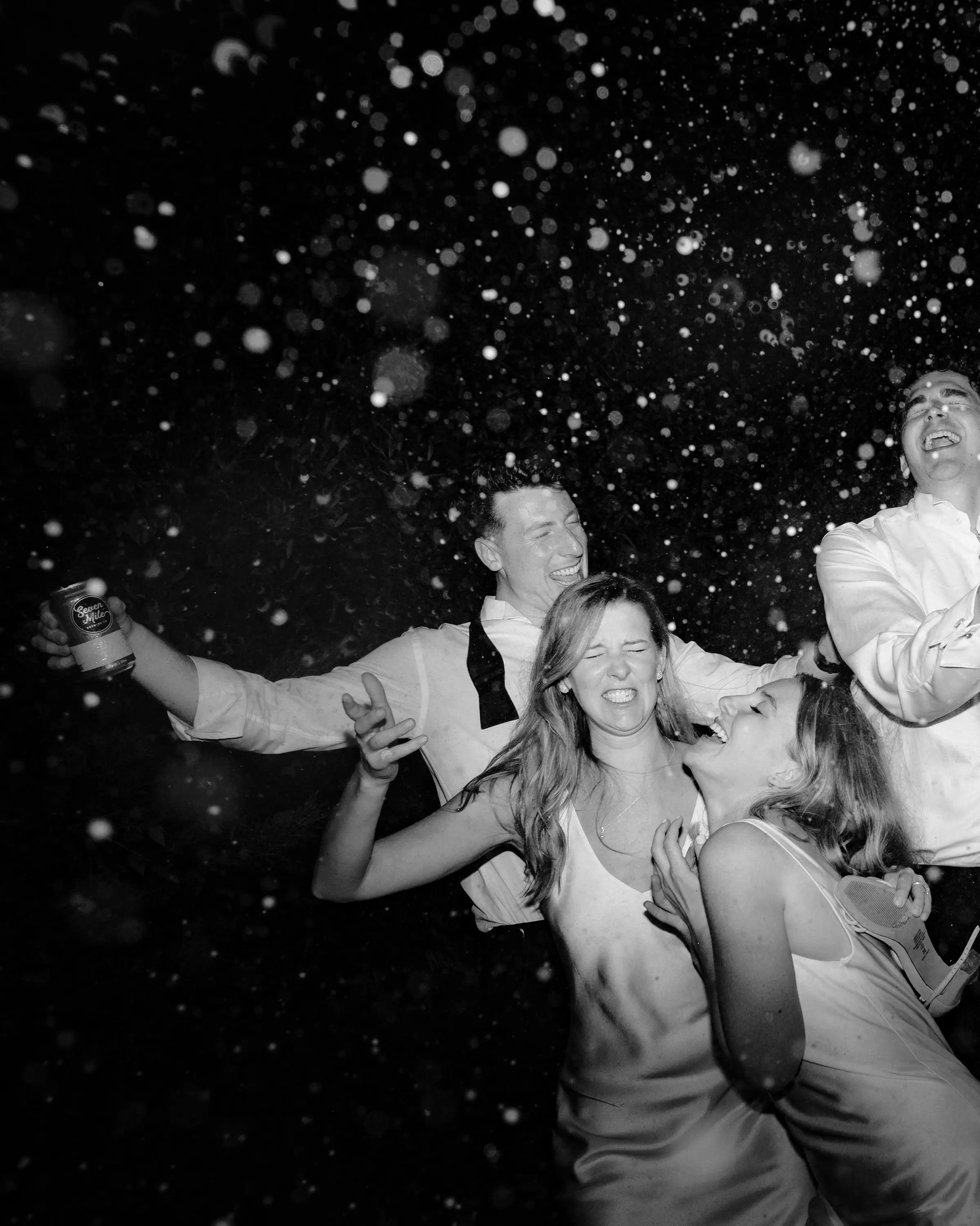 Confetti falling over the first dance, in black and white