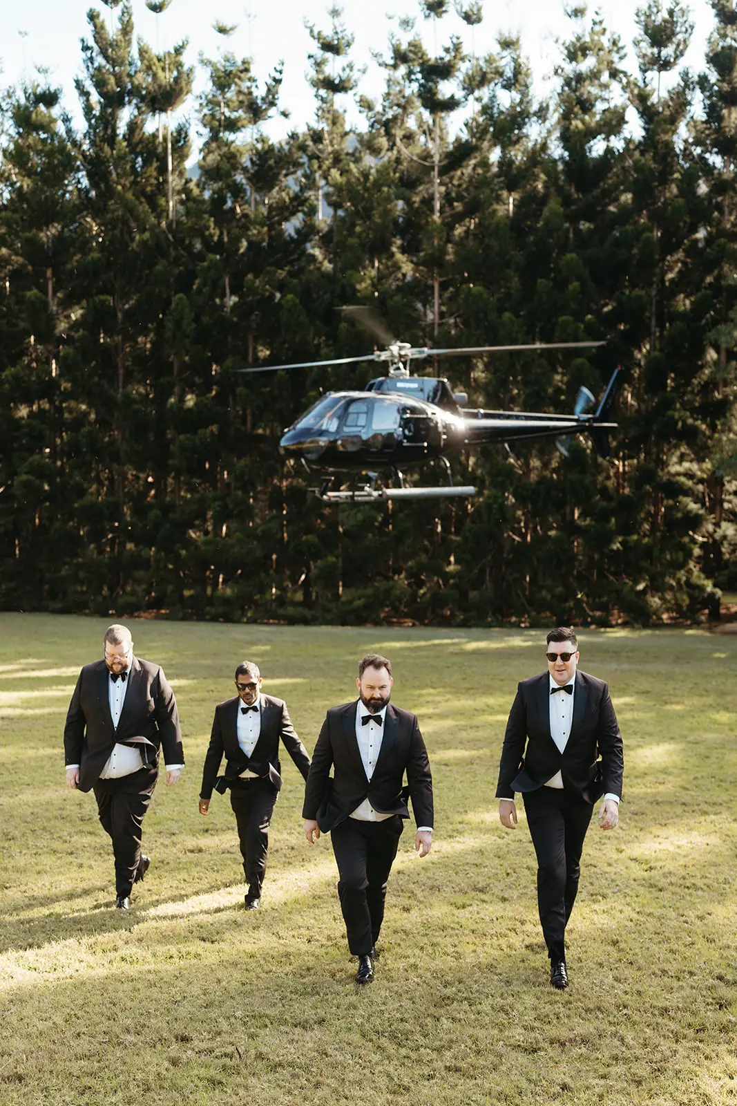 The groomsmen walking up as the helicopter lifts off behind them, The Bower Estate