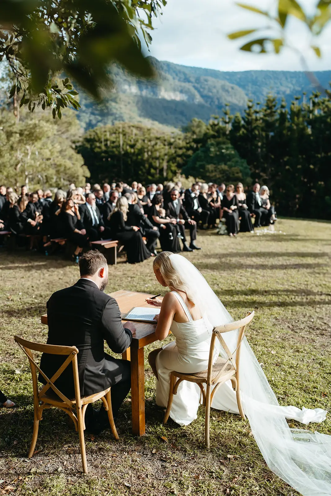 Signing the certificate at a small table above the valley, The Bower Estate