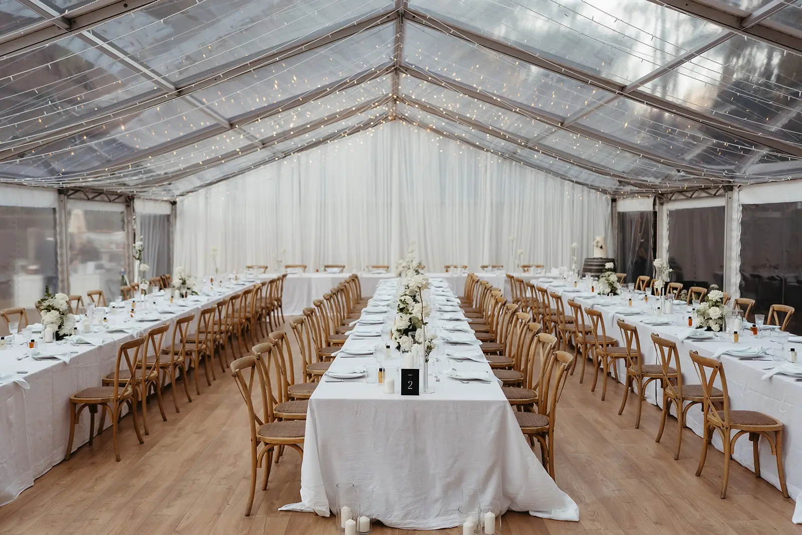 Long tables set beneath the clear marquee, The Bower Estate, Natural Bridge