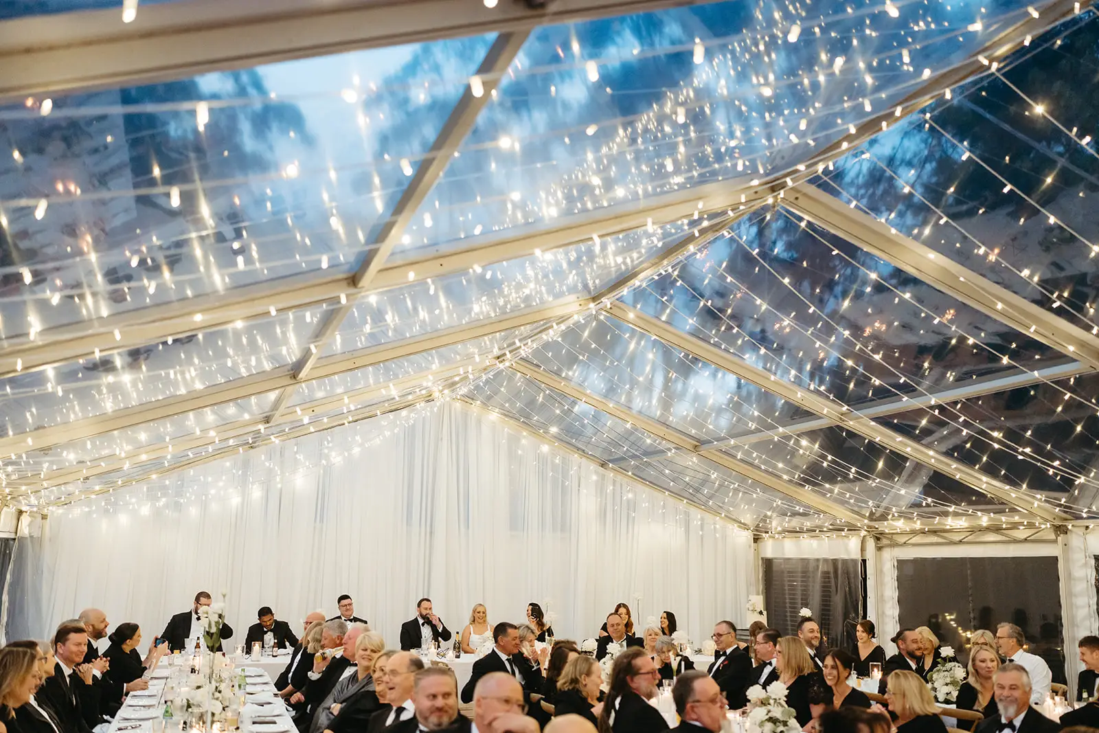 Fairy lights and the night sky through the clear marquee roof, The Bower Estate