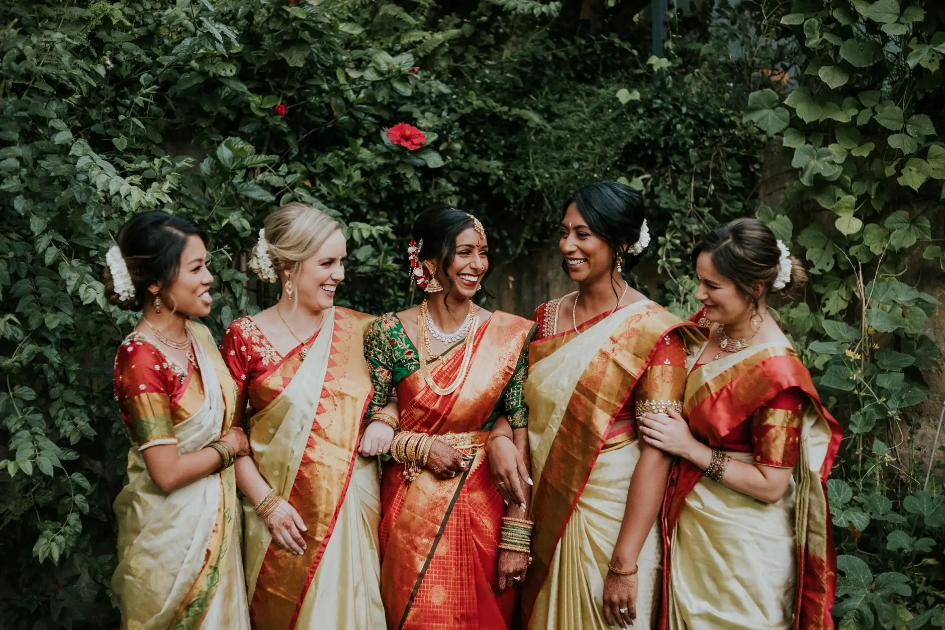 Priyanka with her bridesmaids in silk saris among the greenery