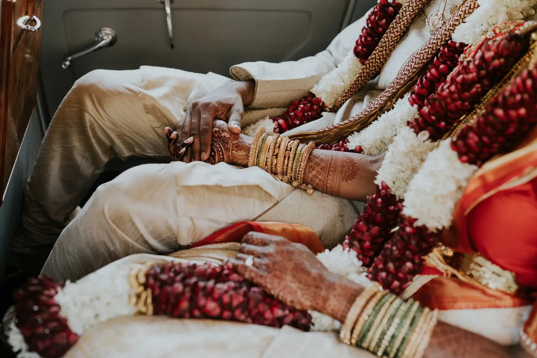 Their garlanded hands resting together in the car, Sydney