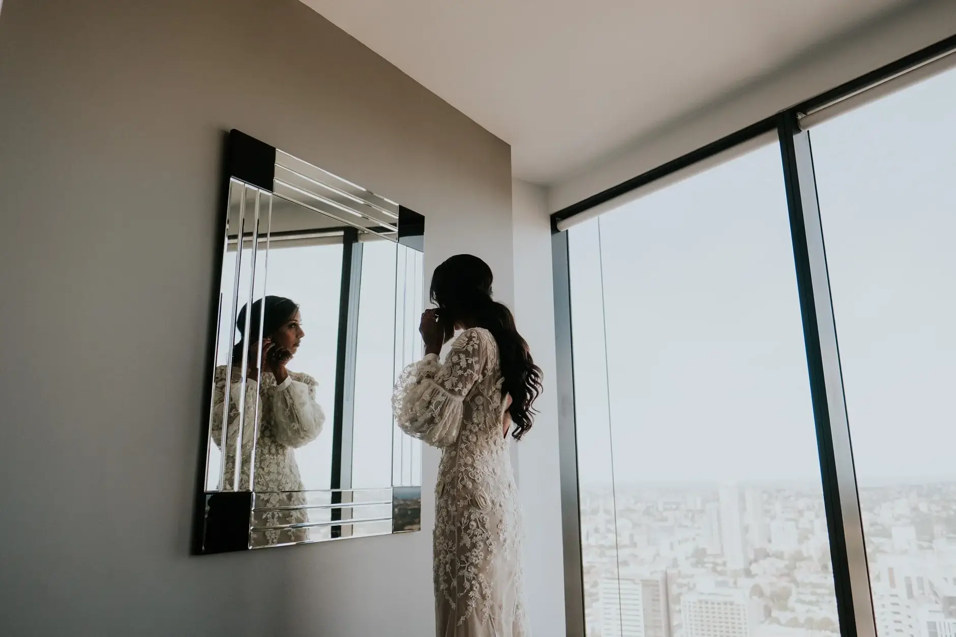 Priyanka reflected in the mirror above the Sydney skyline