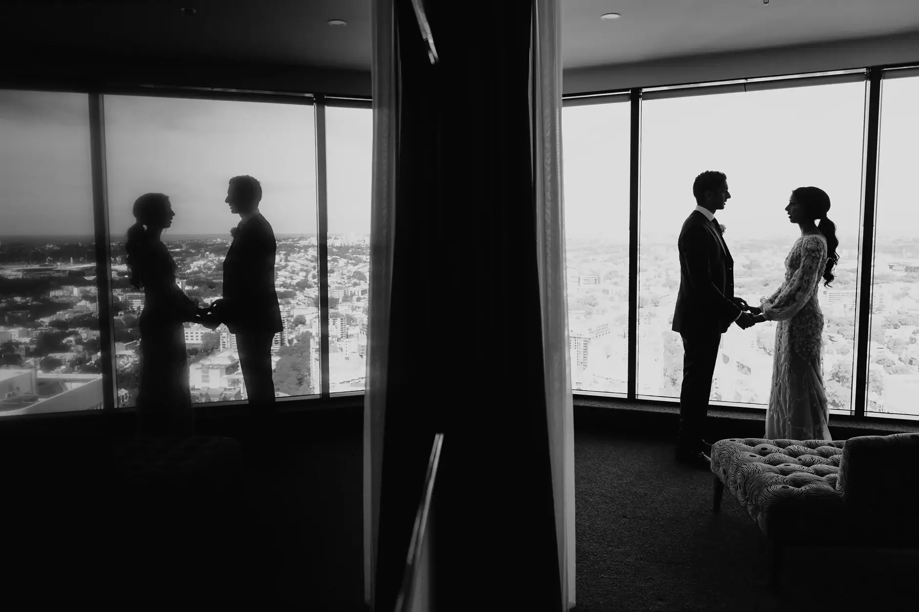 The two of them in silhouette against the city, black and white
