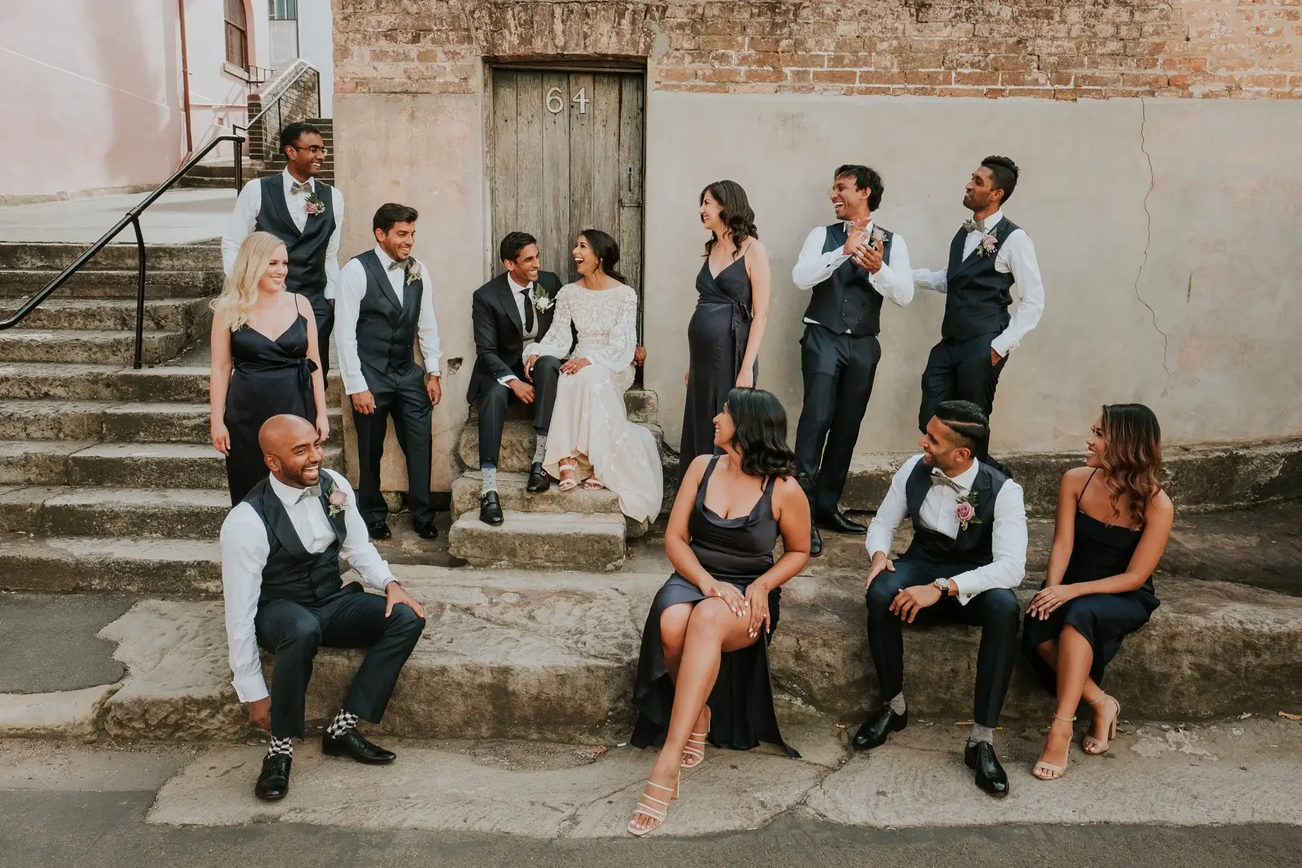 The whole bridal party on the sandstone steps, Sydney