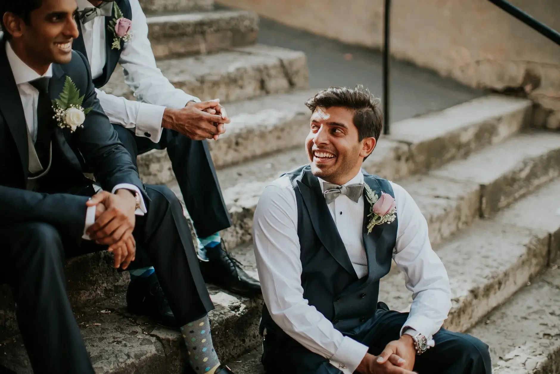 Brahman and the groomsmen sitting on the sandstone stairs
