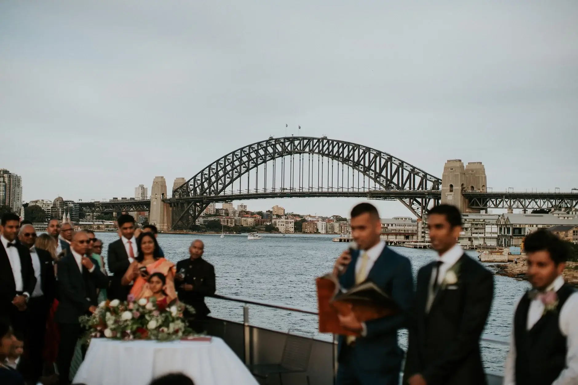 The celebrant and groomsmen beneath the Harbour Bridge, Sydney