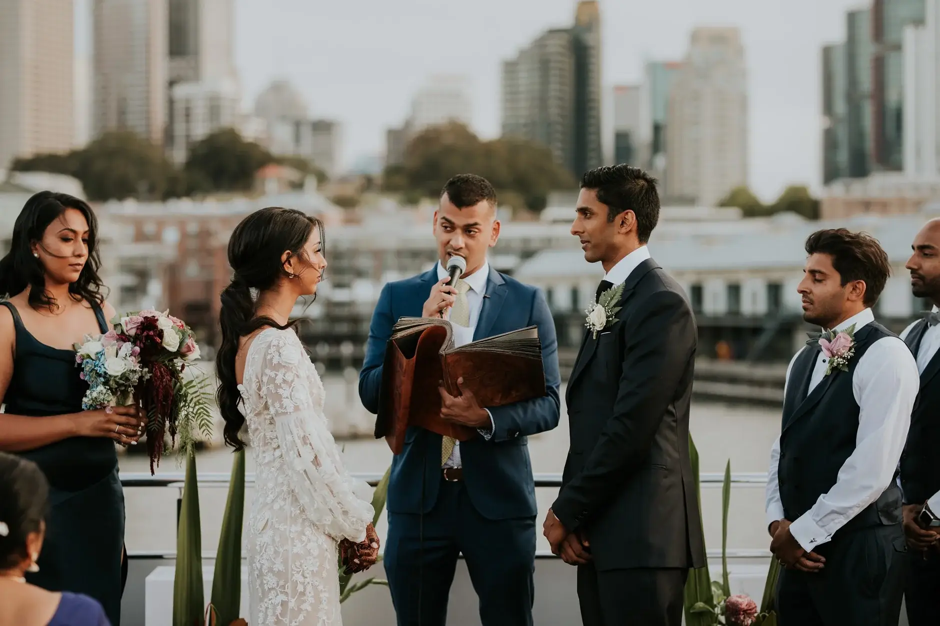 Priyanka and Brahman with the celebrant on the wharf, Sydney