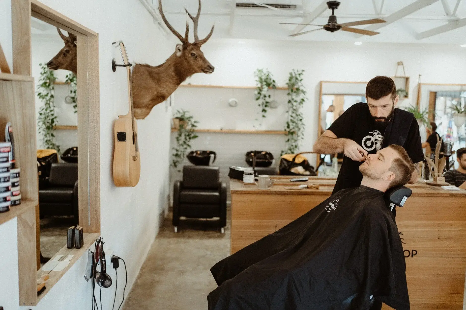 Matt in the barber's chair having his hair cut before the wedding, Byron Bay