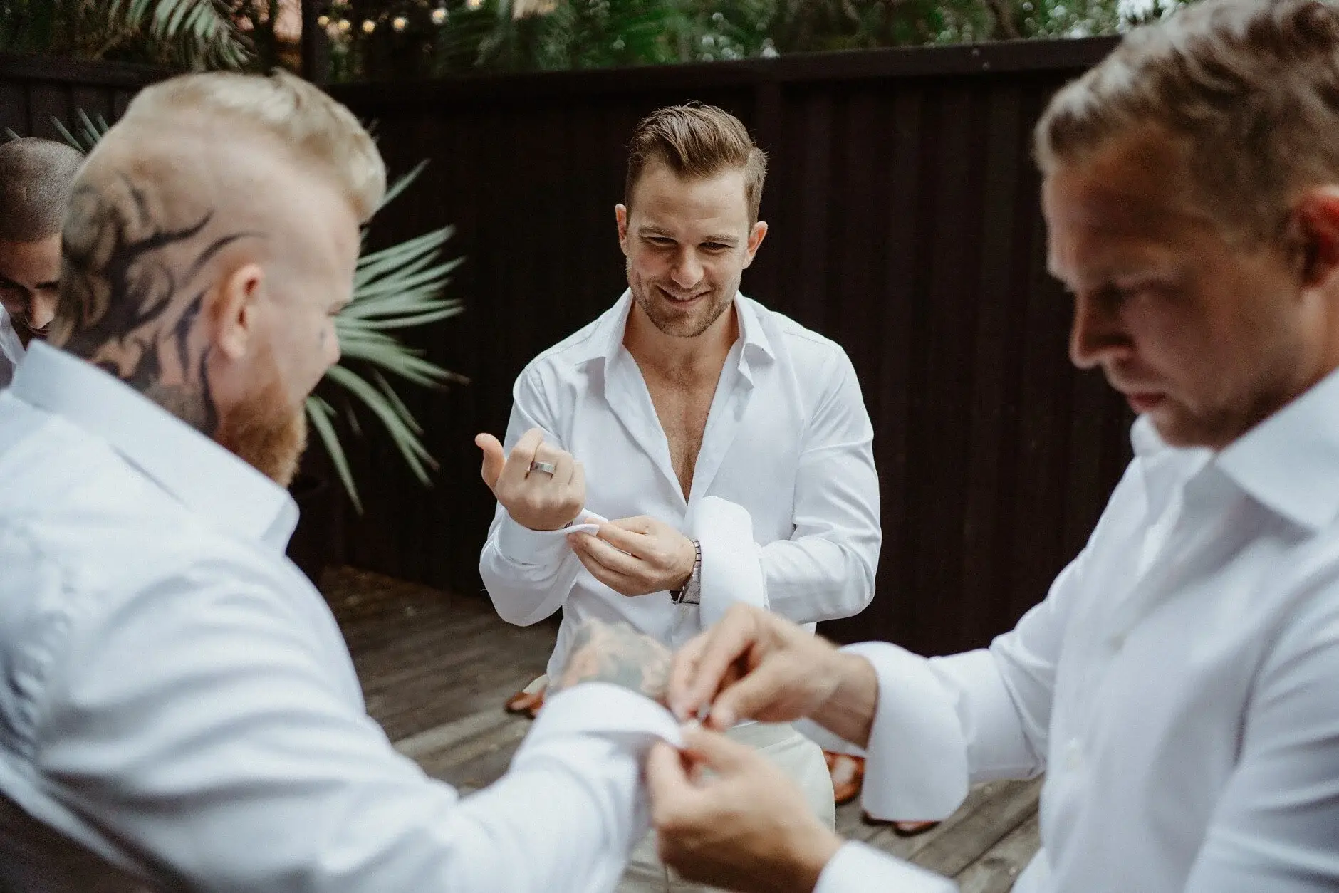 Two of the groomsmen fixing Matt's cuffs, Byron Bay