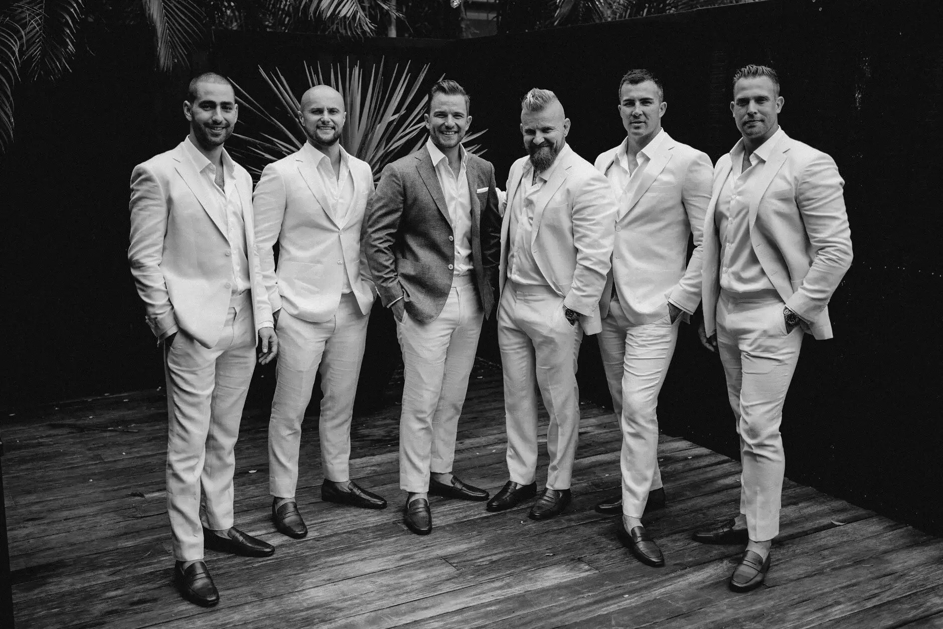 The groomsmen walking together in linen suits, black and white, Byron Bay