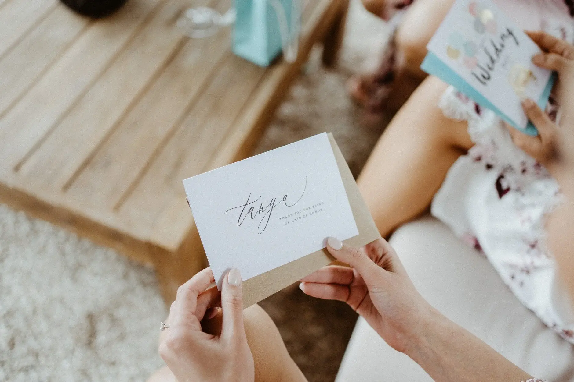 A card held open over a timber table, Byron Bay
