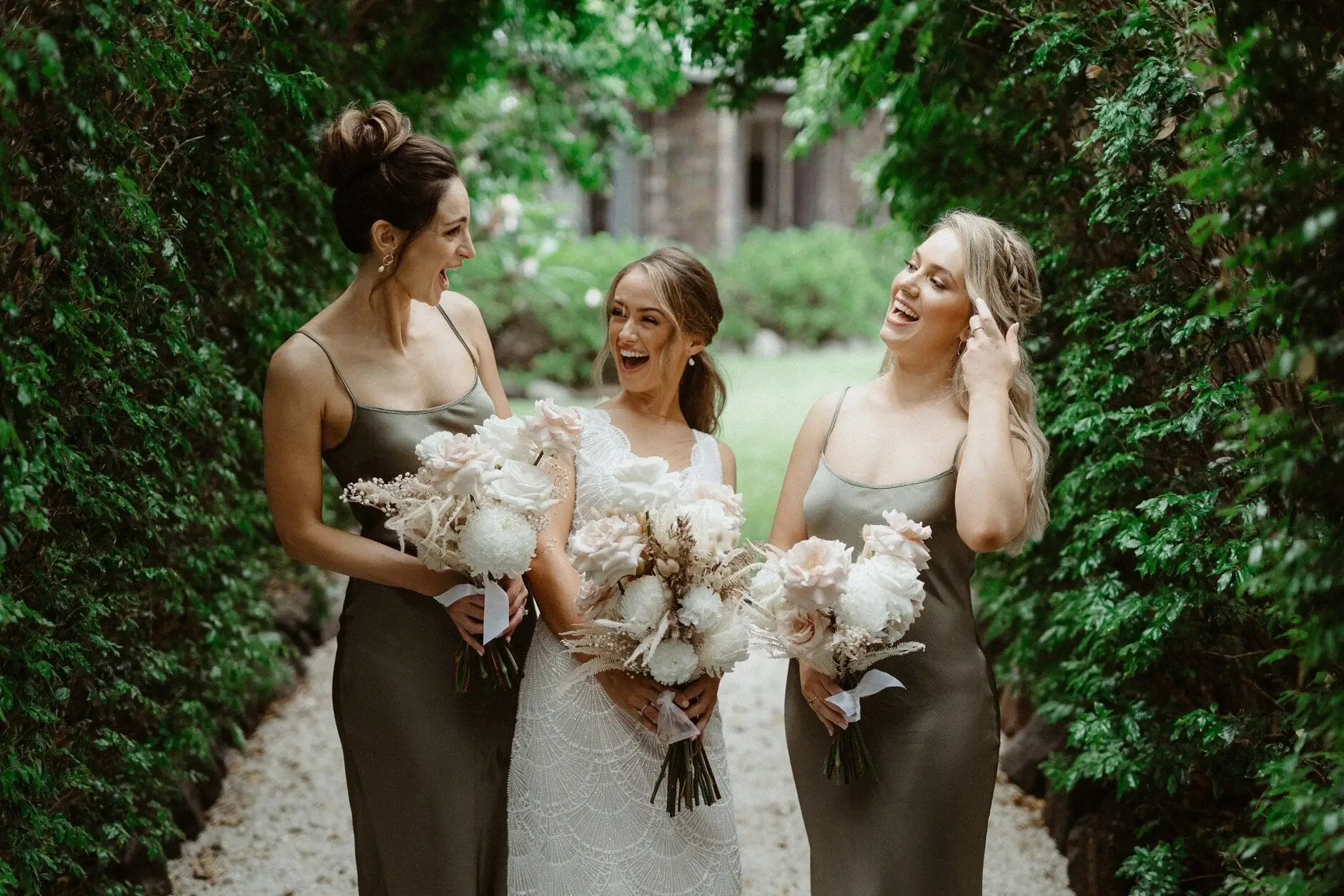 The bridesmaids laughing together with their bouquets, Byron Bay