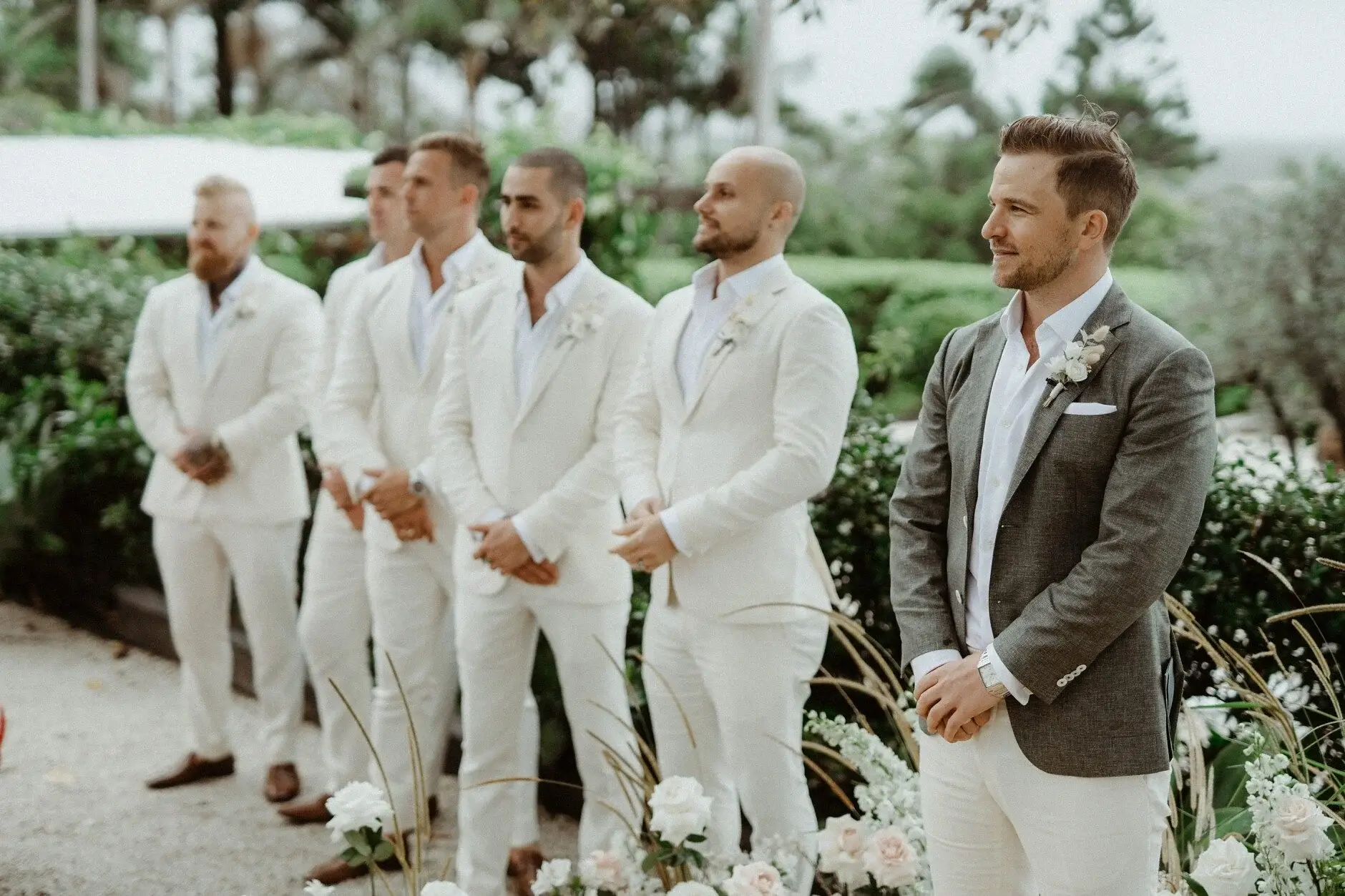 The groomsmen standing together before the ceremony begins, The Fig Tree Byron Bay
