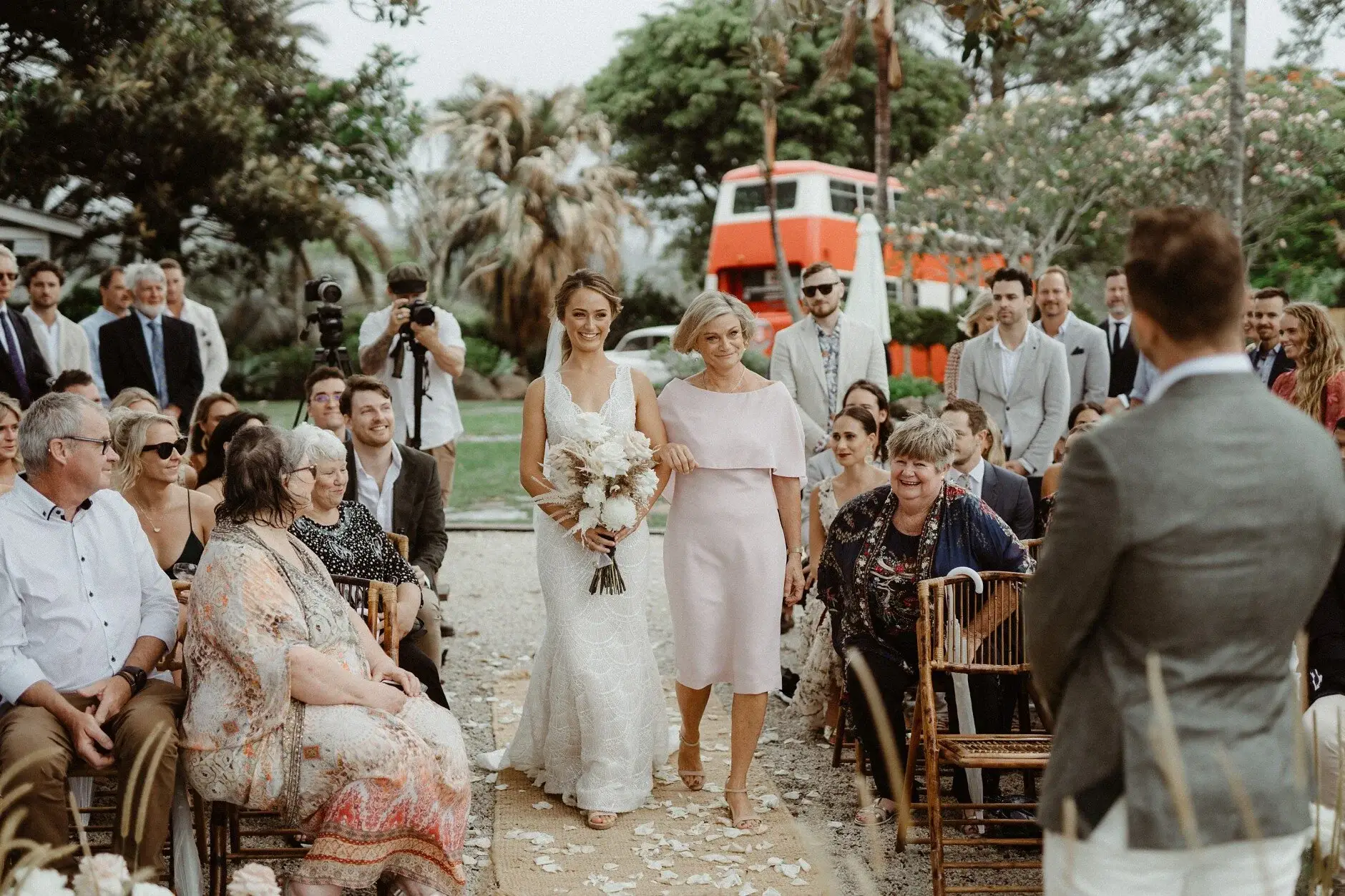 Breanna on her way down the aisle with her bouquet, The Fig Tree Byron Bay