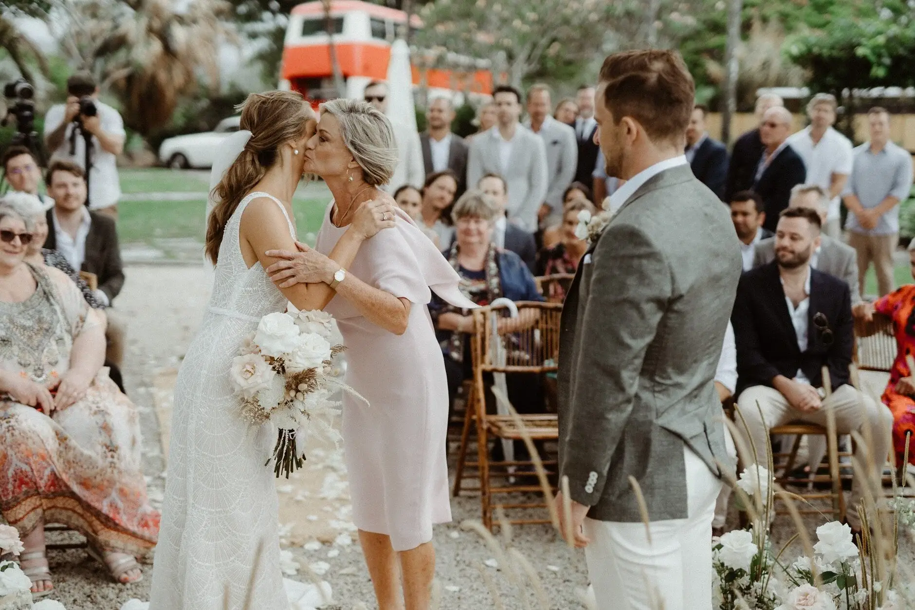Breanna hugging a guest on her way to the ceremony, The Fig Tree Byron Bay