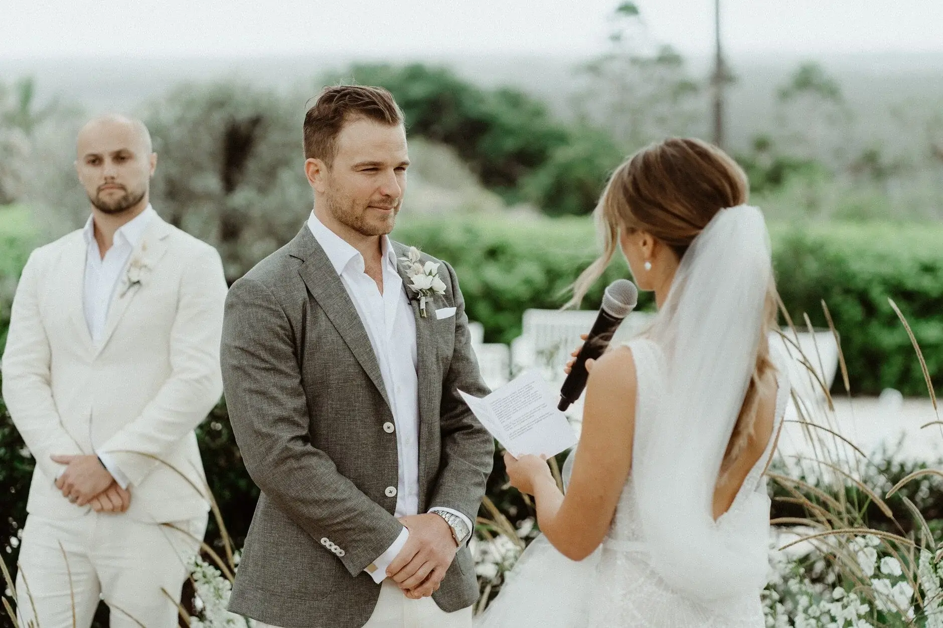 Breanna and Matt facing each other during the ceremony, The Fig Tree Byron Bay