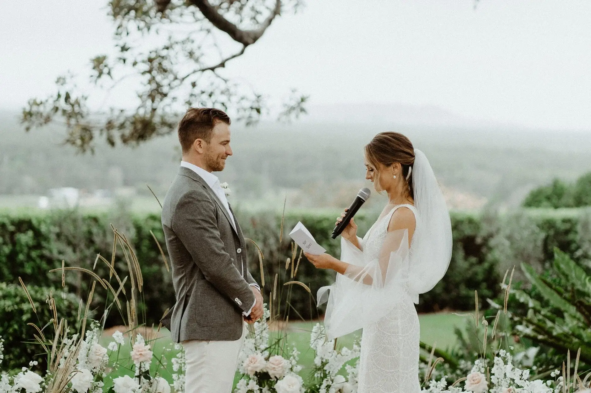Breanna and Matt exchanging vows with the valley beyond, The Fig Tree Byron Bay