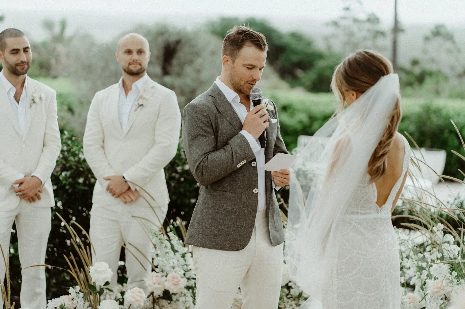 Breanna and Matt laughing together during the ceremony, The Fig Tree Byron Bay