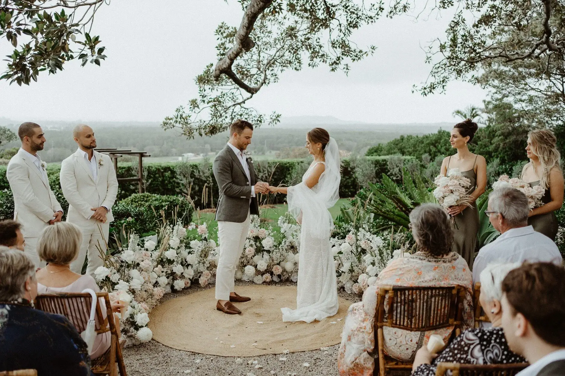The couple at the front with guests watching from the chairs, The Fig Tree Byron Bay