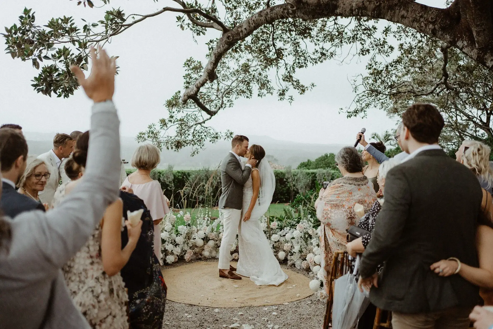 Breanna and Matt's first kiss as guests cheer beneath the fig tree, The Fig Tree Byron Bay