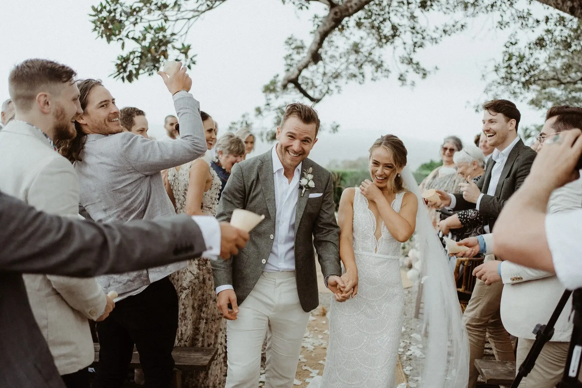Breanna and Matt walking back through the cheering guests, The Fig Tree Byron Bay