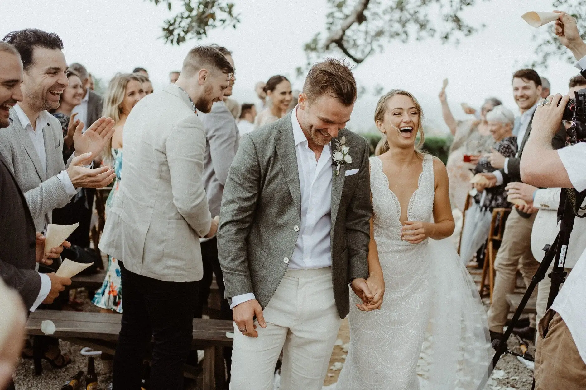 Breanna and Matt laughing as guests crowd around them, The Fig Tree Byron Bay
