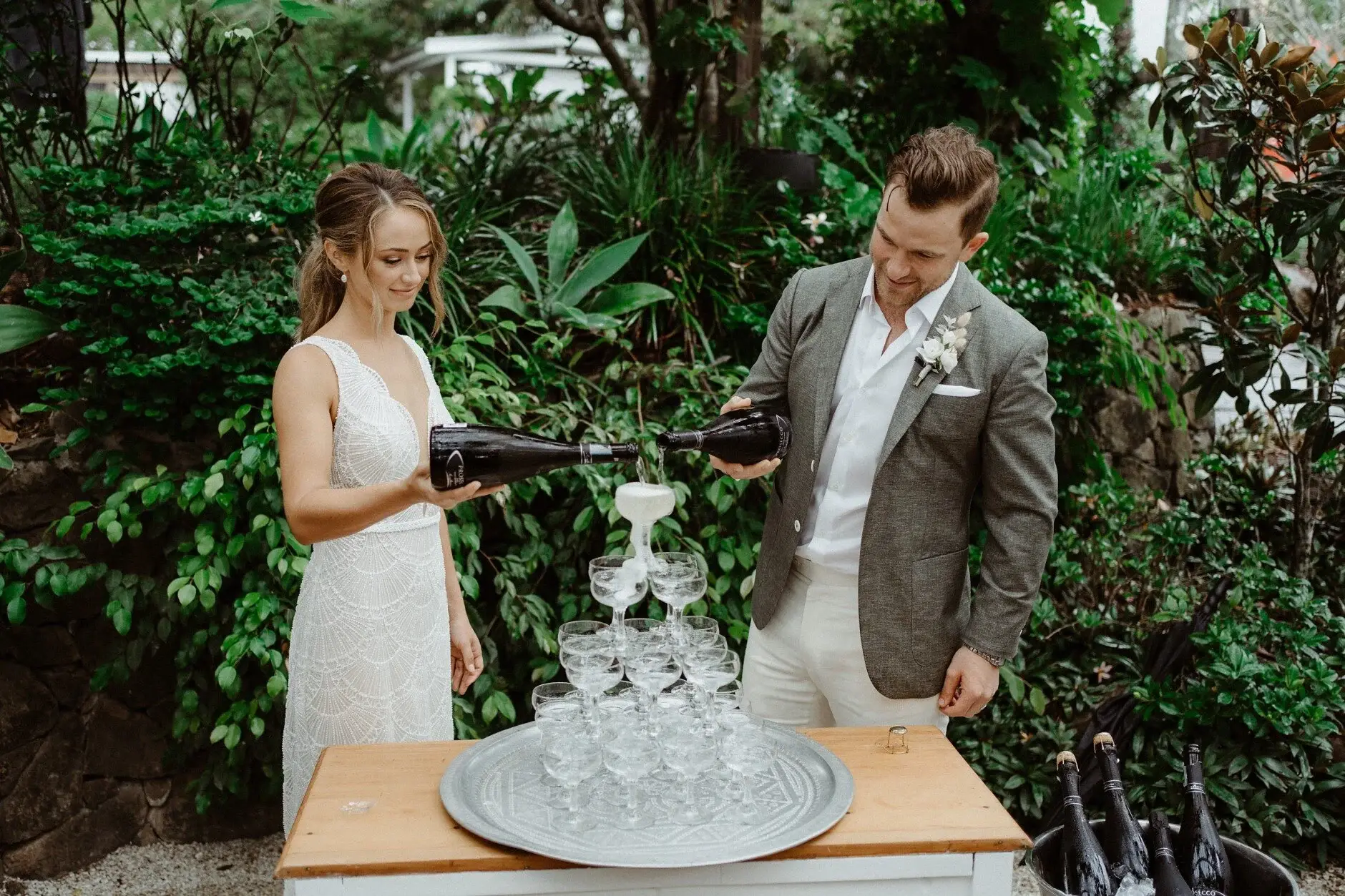 The couple pouring champagne over the glass tower, The Fig Tree Byron Bay