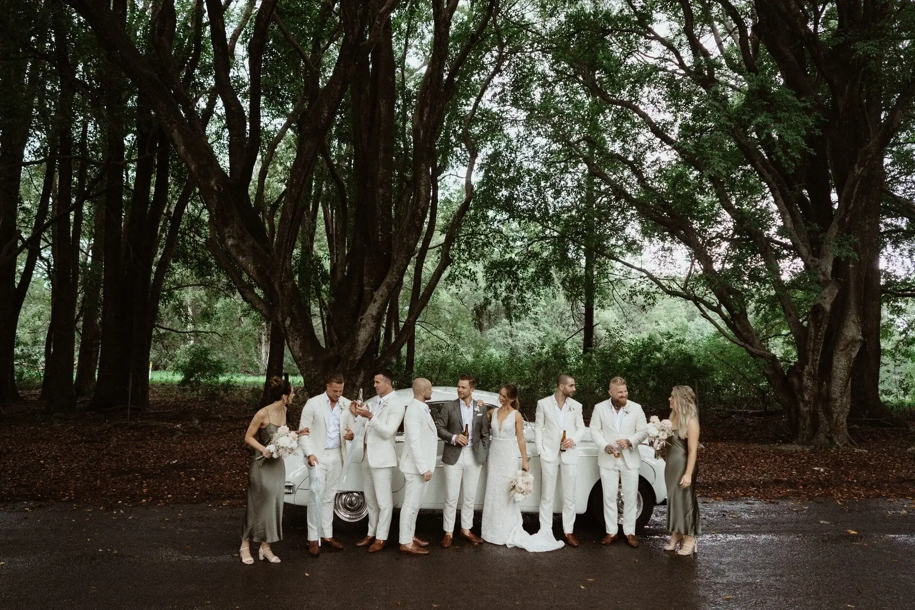 The bridal party walking together under the trees, Byron Bay