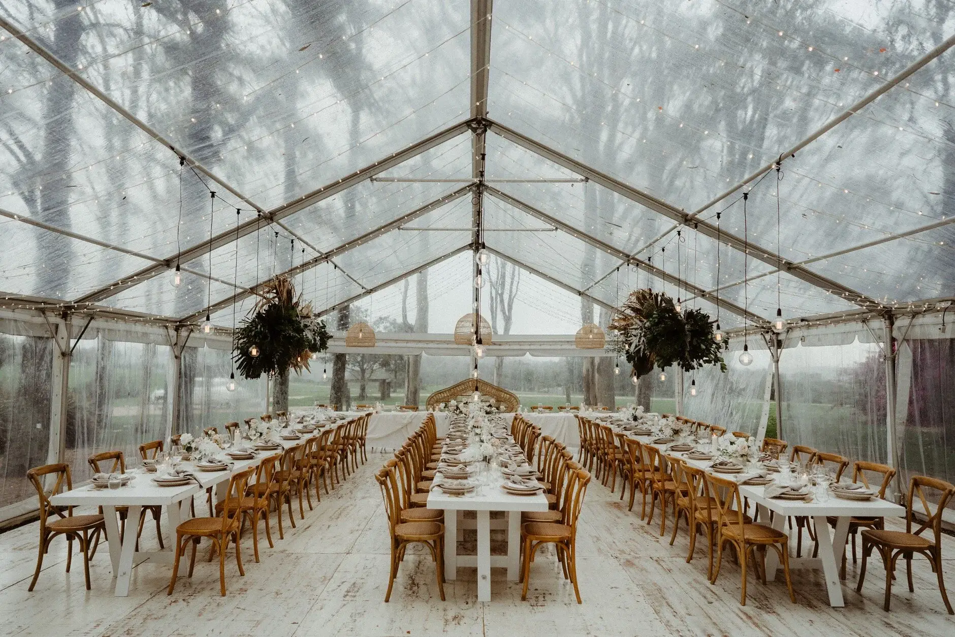 The long reception tables set beneath the clear marquee, Byron View Farm