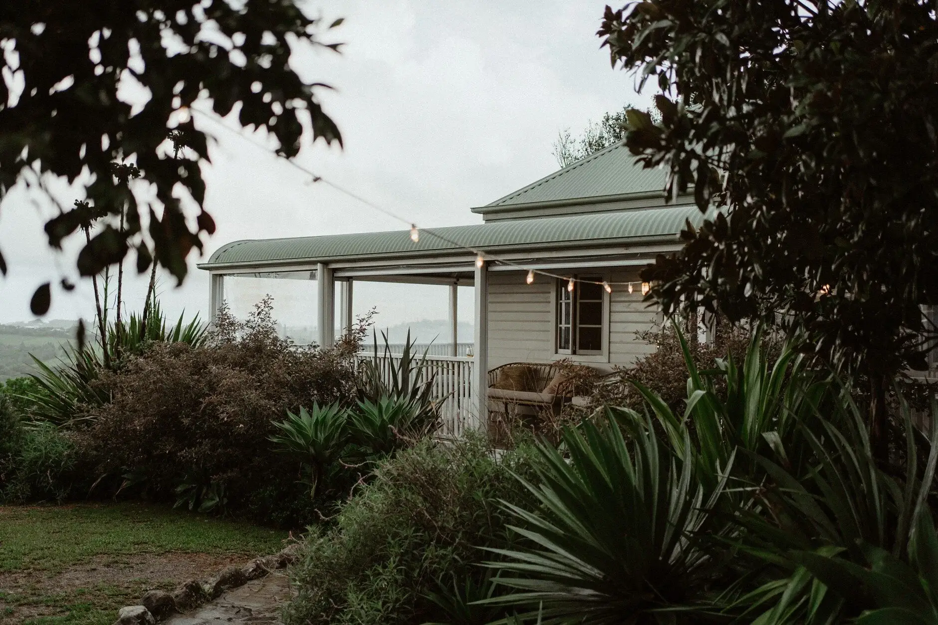 The farmhouse and its garden under a grey sky, Byron View Farm