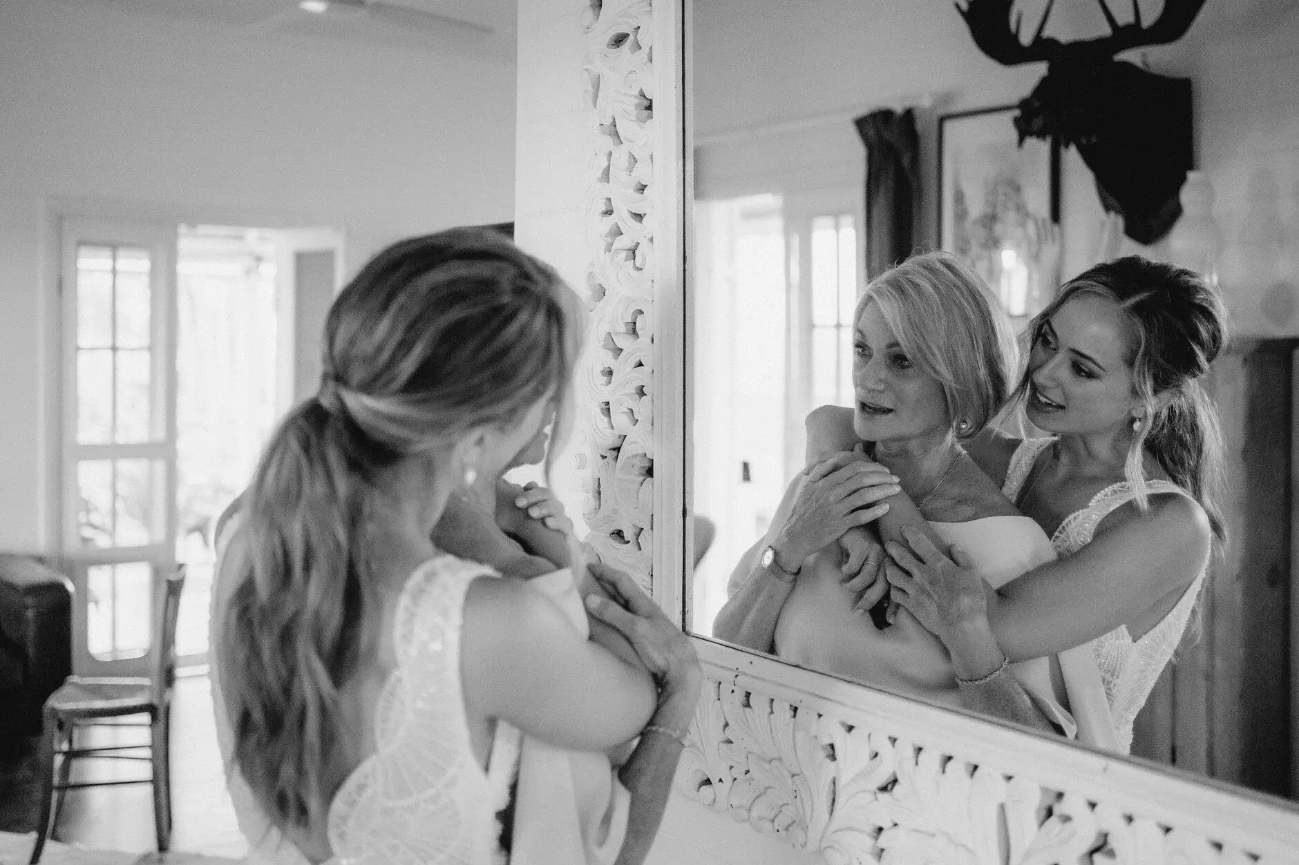 Breanna and a friend laughing together indoors, black and white, Byron View Farm